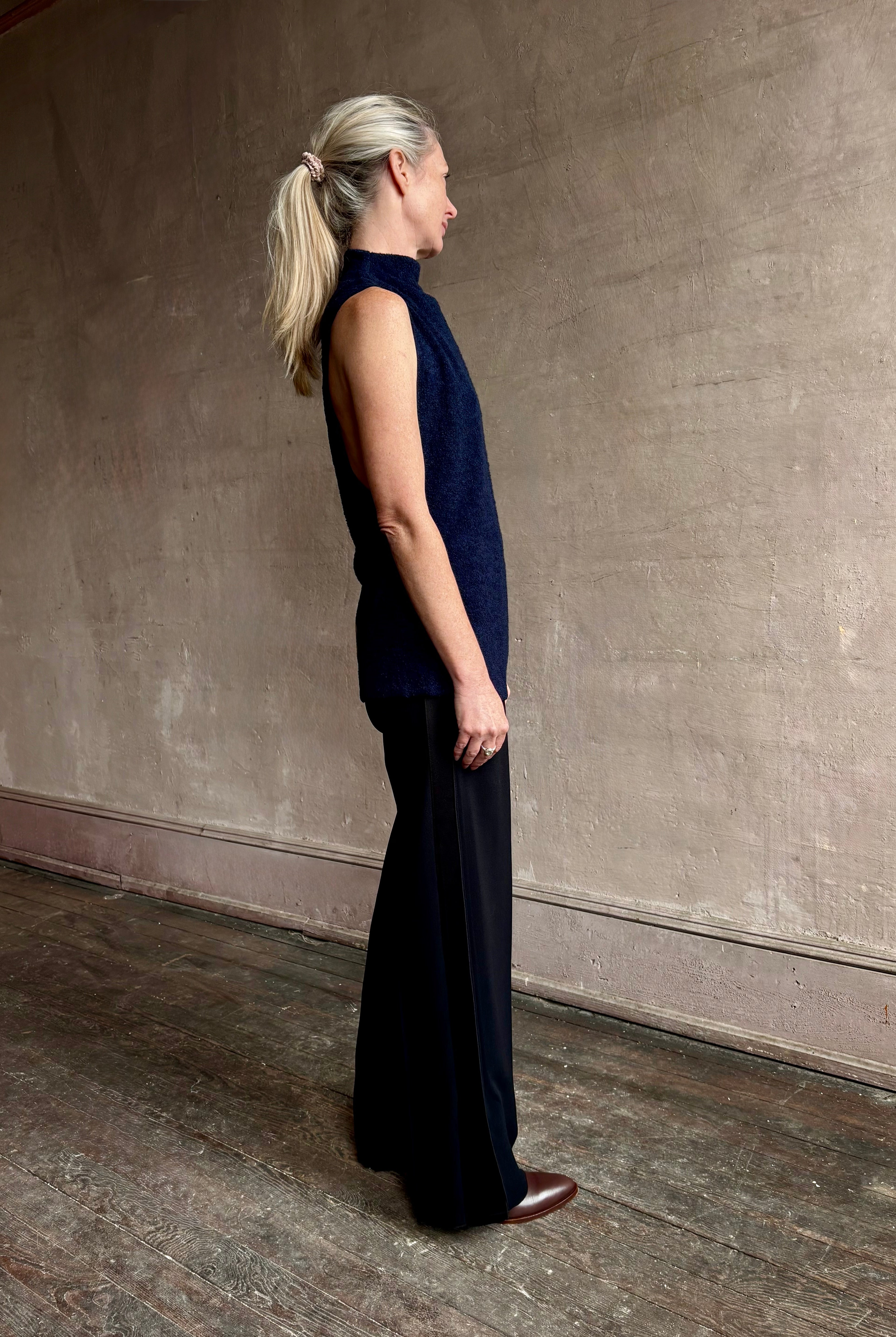 Image of mature woman wearing proenza schouler cynthia sleeveless top in a boucle texture and a mock neck
