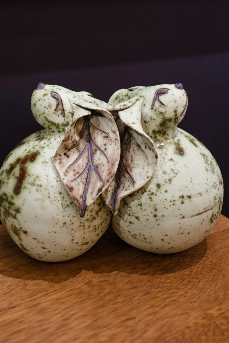 Image featuring North Carolina pottery artist Pam Brewer Art of Leaning sculpture hand built pottery of two bunnies or rabbits