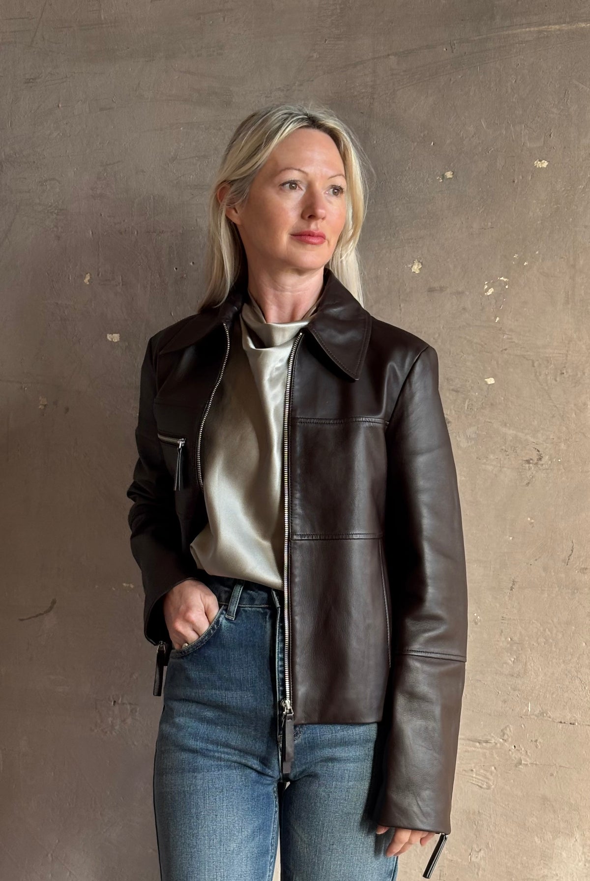 Proenza Schouler’s White Label Annabel Leather Jacket in Chocolate Brown: 100% lambskin biker with a two-way zip and sleeve zips. Supple, architectural