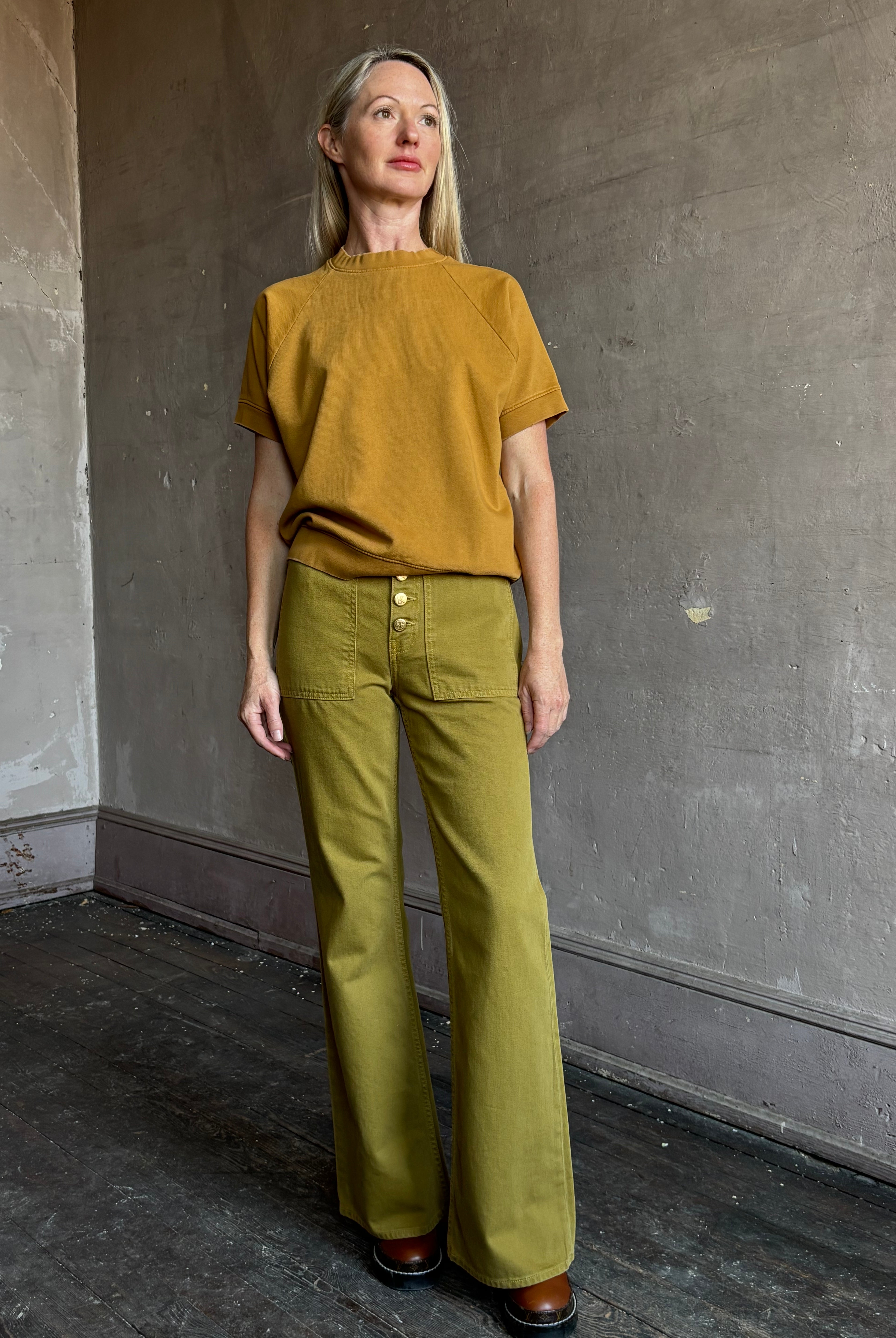 Image of mature woman wearing NY designer Rachel Comey Billi short sleeve sweatshirt in mustard gold