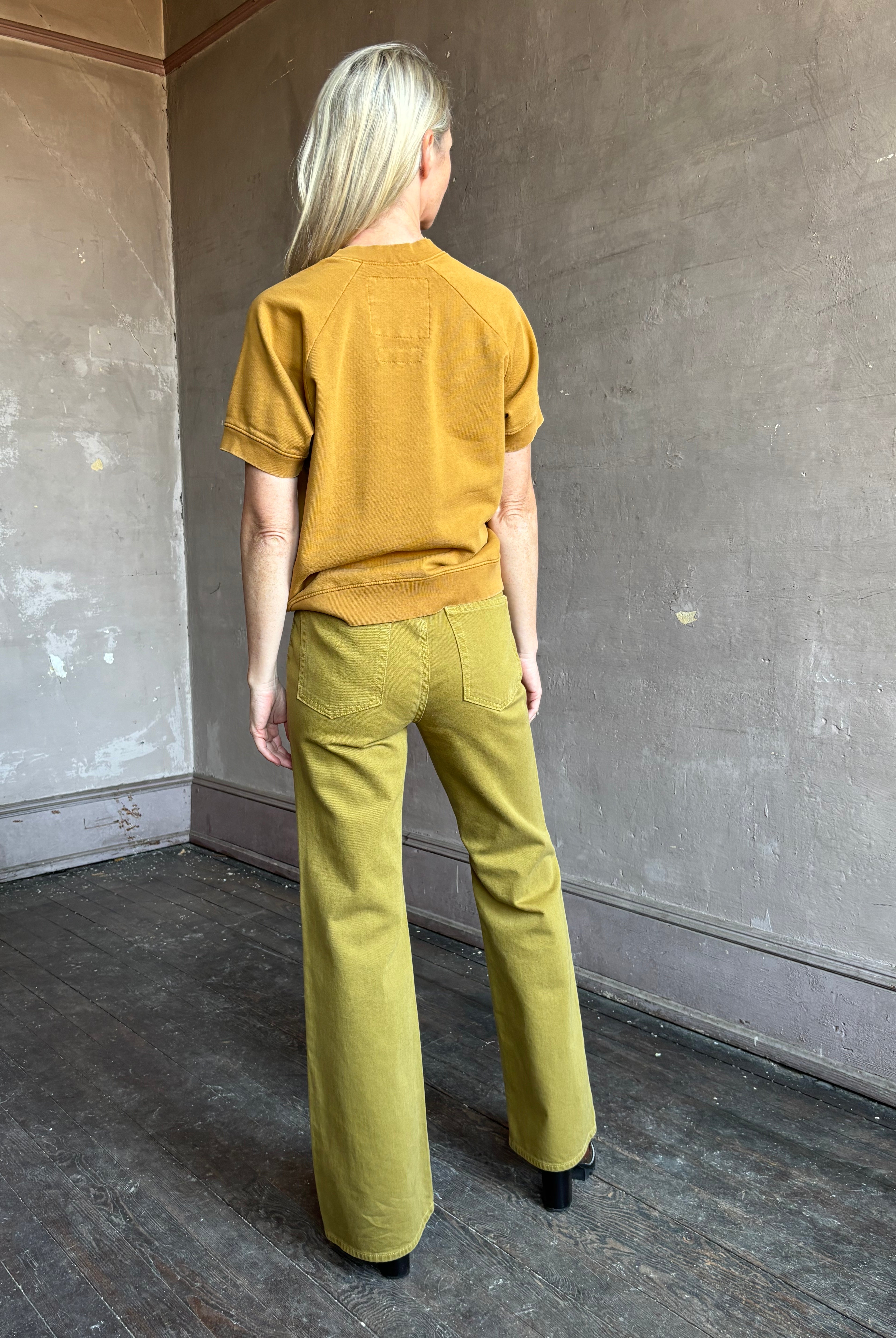 Image of mature woman wearing NY designer Rachel Comey Billi short sleeve sweatshirt in mustard gold