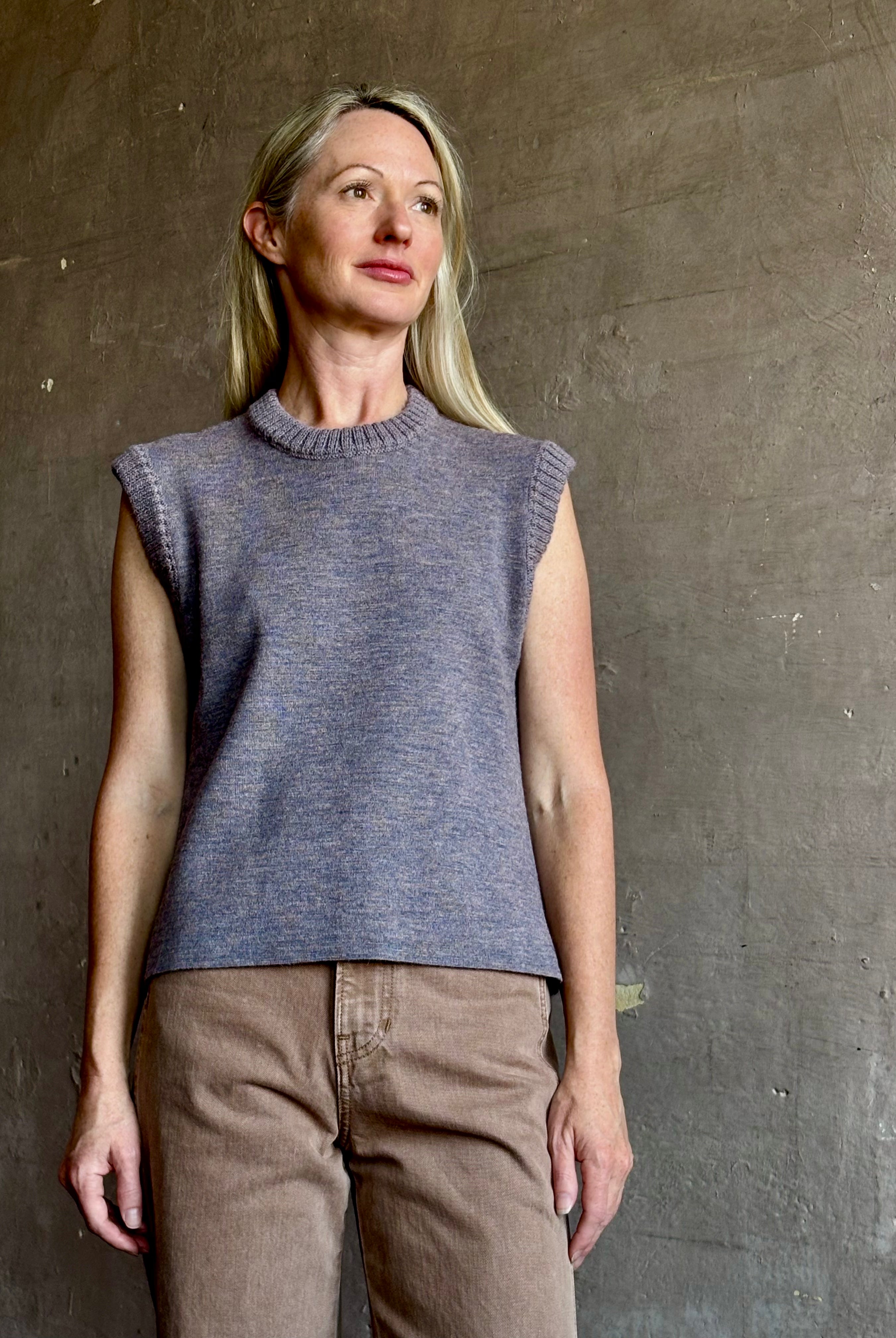 Mature woman wearing a quality sleeveless lilac knit top fabricated from baby alpaca by designer Rachel Comey