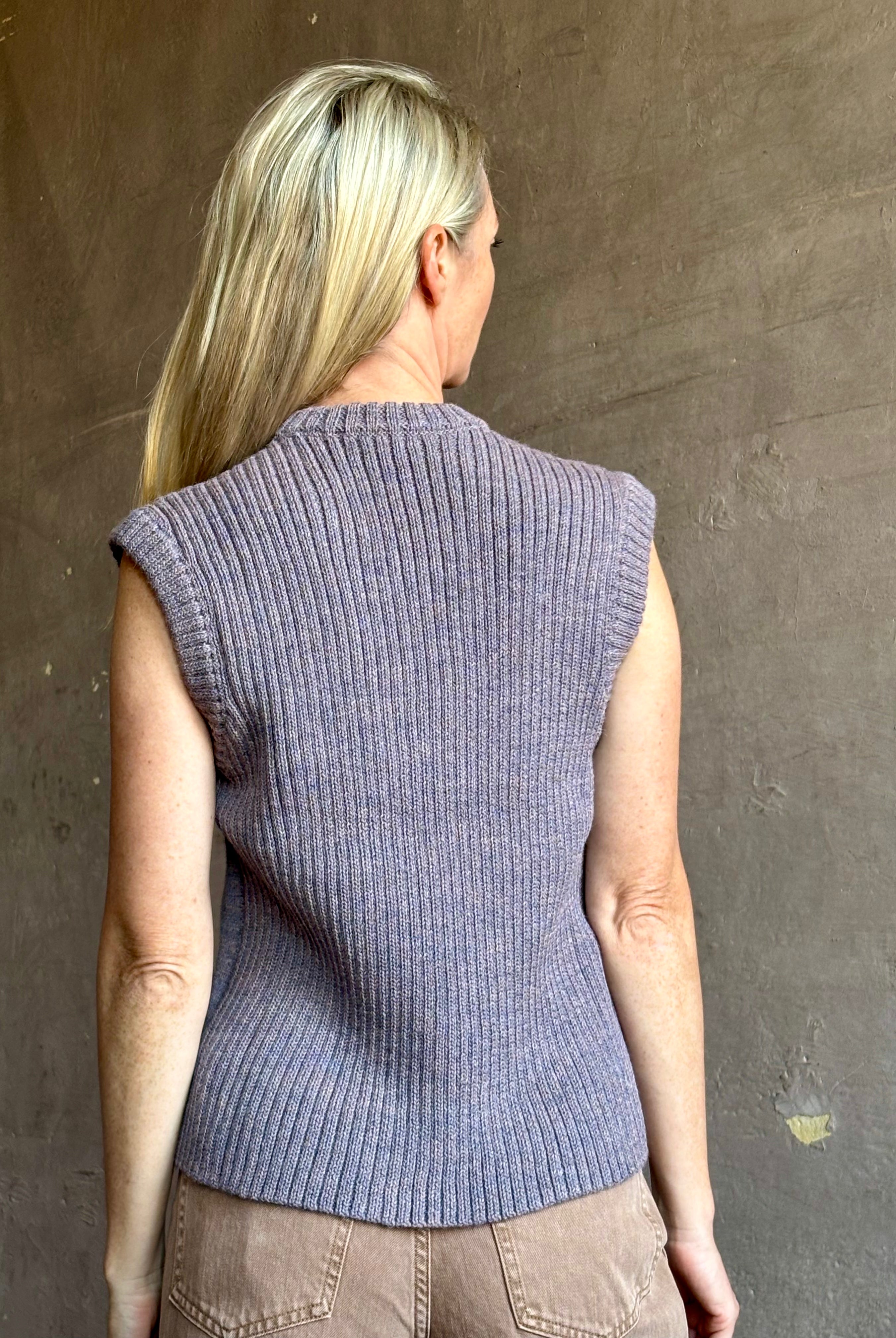 Mature model wearing a quality lilac knit top fabricated from baby alpaca by designer Rachel Comey