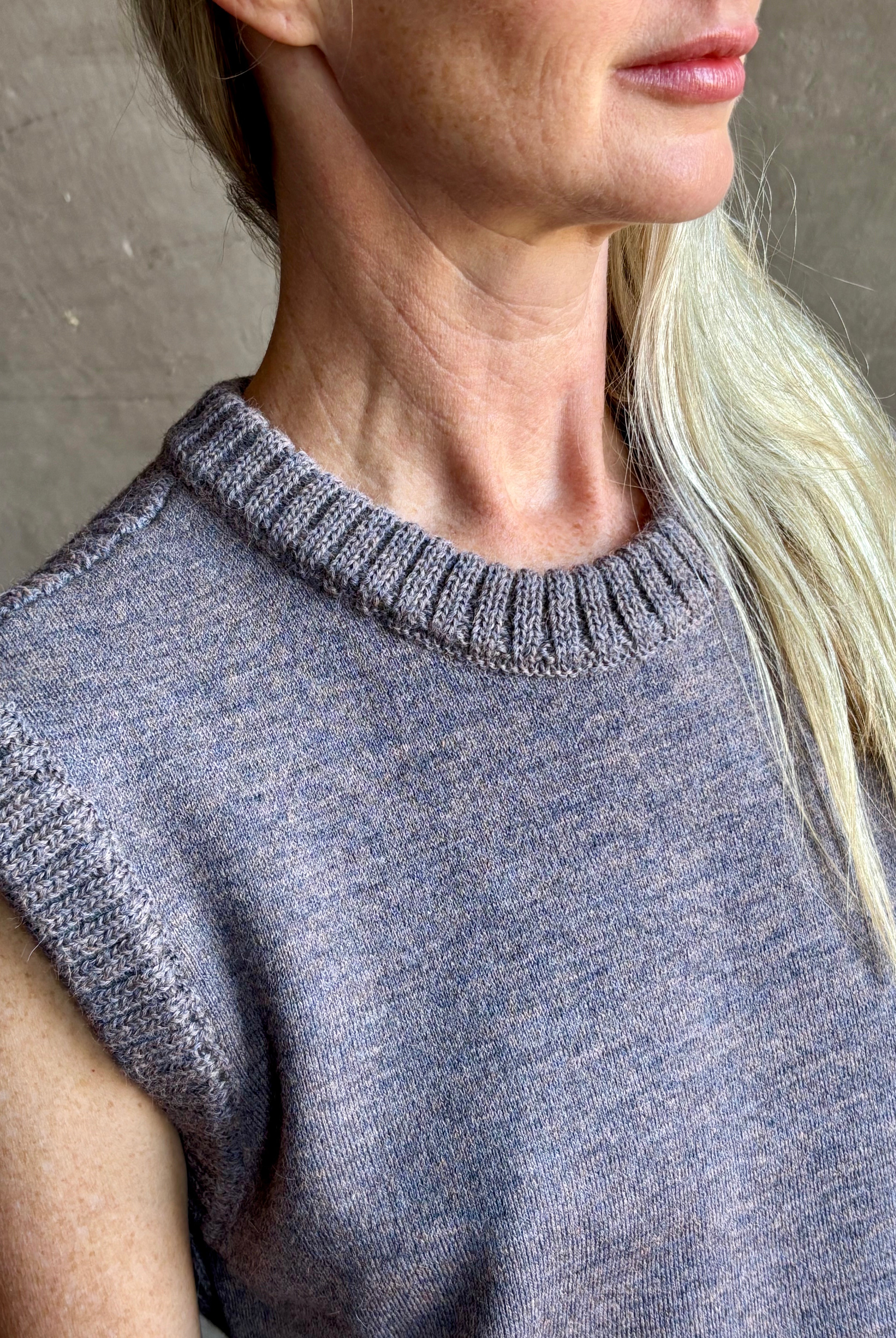 Mature model wearing a quality lilac knit top fabricated from baby alpaca by designer Rachel Comey