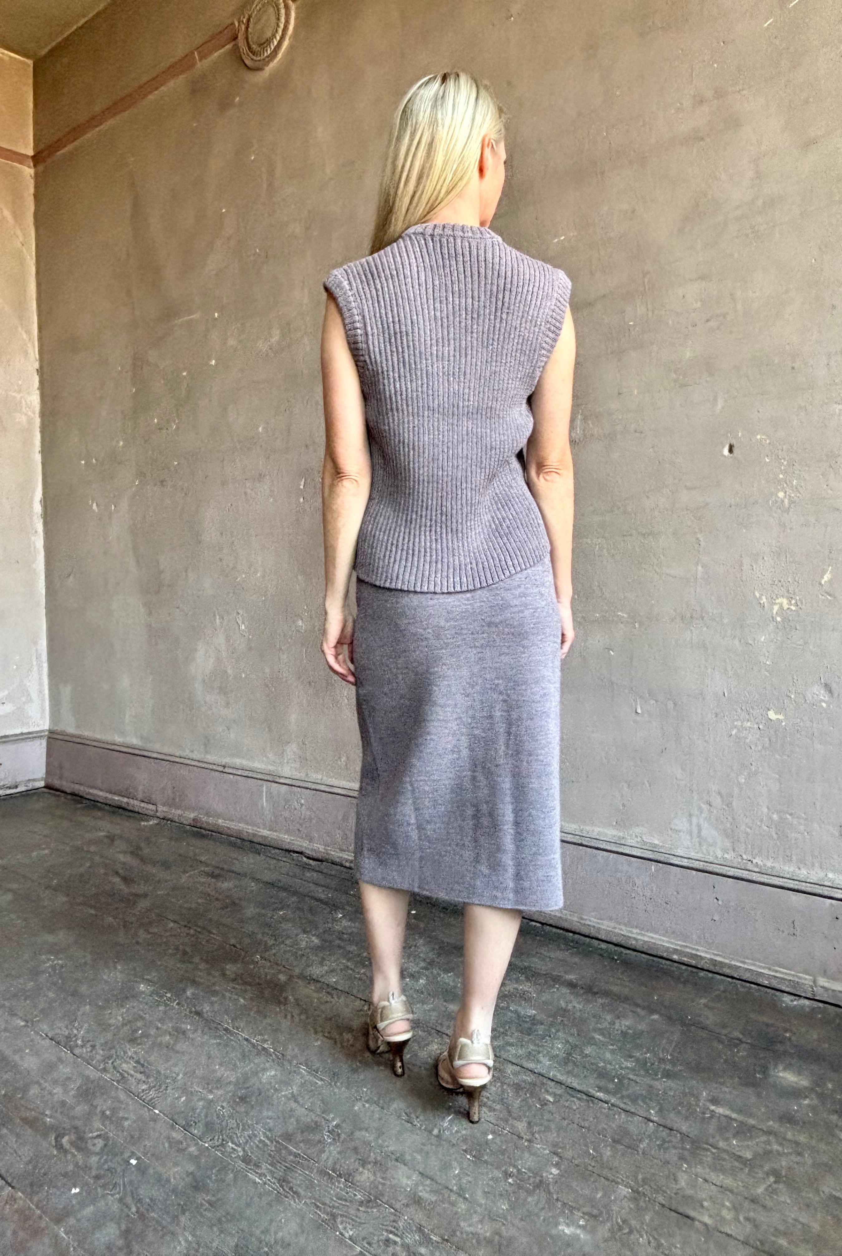 Mature model wearing a quality lilac knit skirt and top set fabricated from baby alpaca by designer Rachel Comey