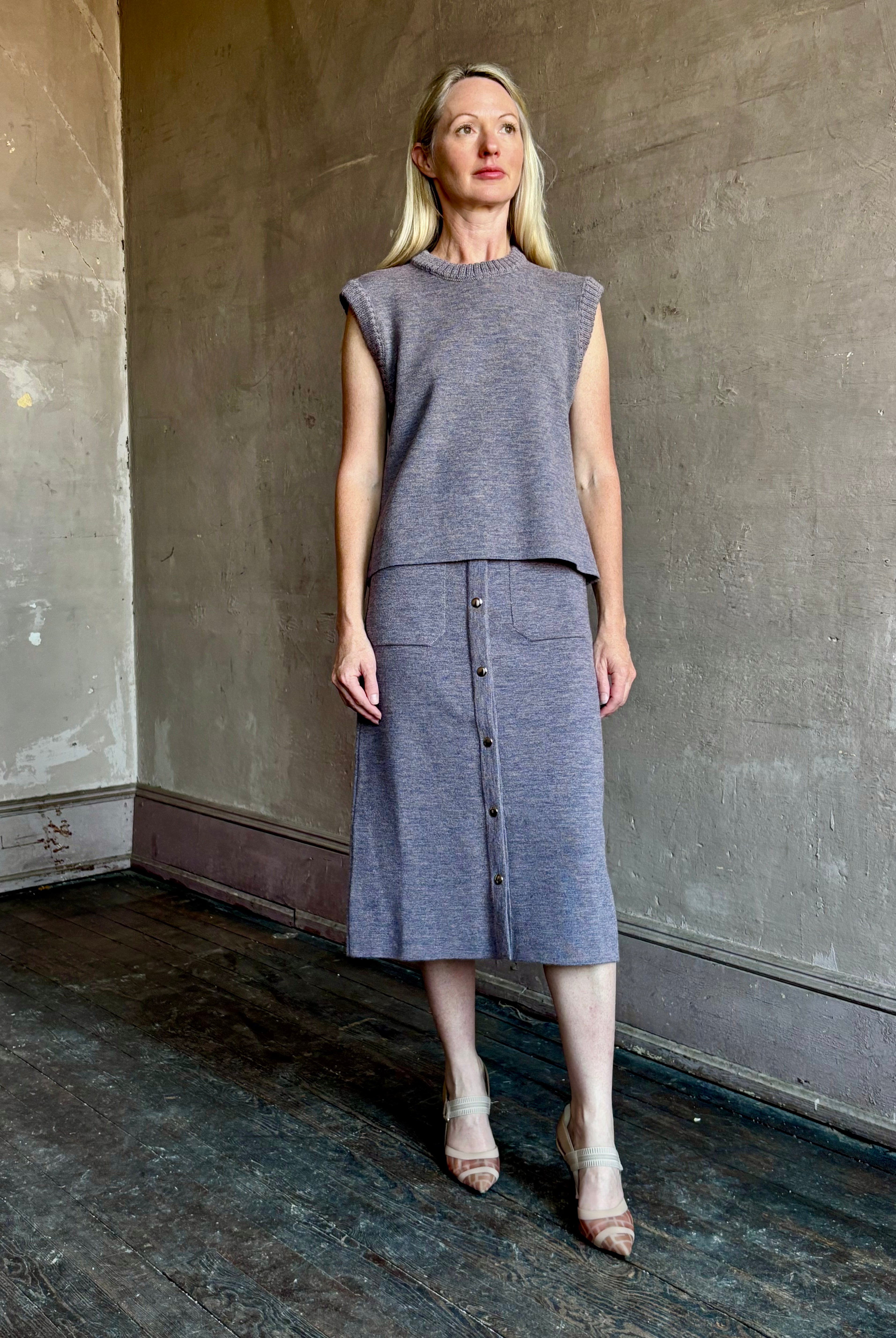 Mature model wearing a quality lilac knit skirt and matching top fabricated from baby alpaca by designer Rachel Comey