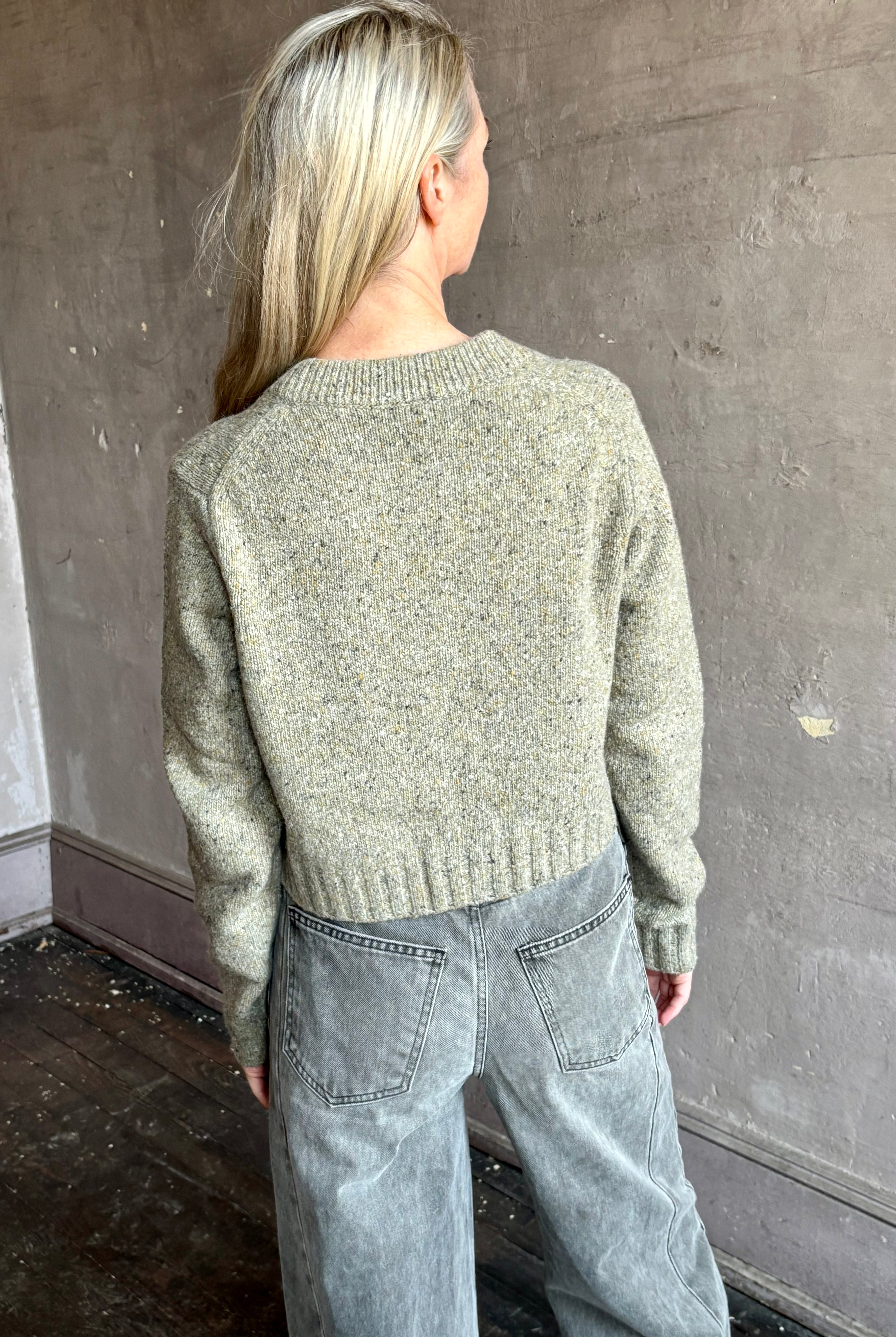 Image of mature woman wearing American designer Rachel Comey Uridge Cardigan in sophisticated green with a flattering U-neckline