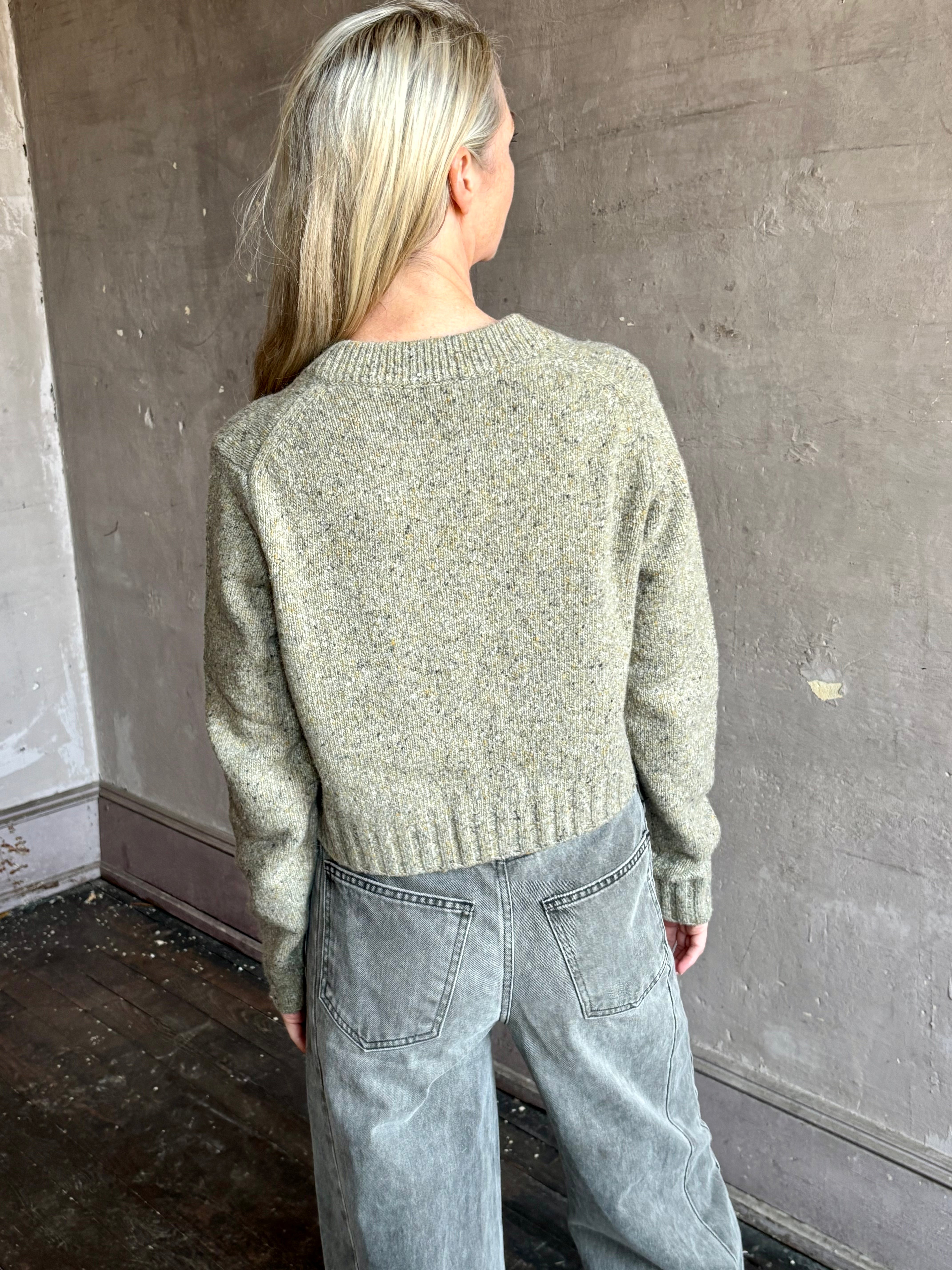 Image of mature woman wearing American designer Rachel Comey Uridge Cardigan in sophisticated green with a flattering U-neckline