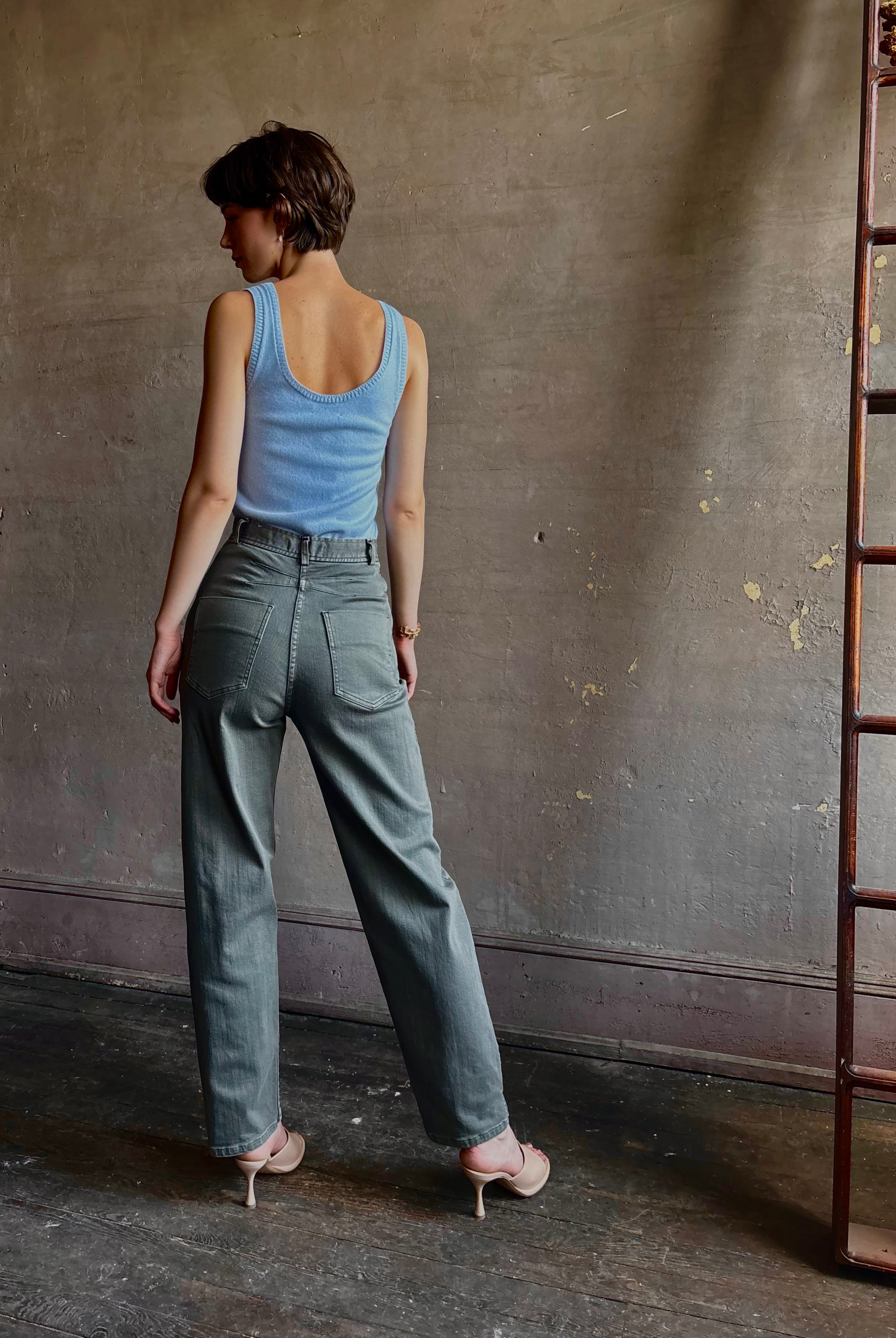 Woman wearing designer Rachel Comey Dardo green stretch cotton Pant intricate back detail similar to Alaia