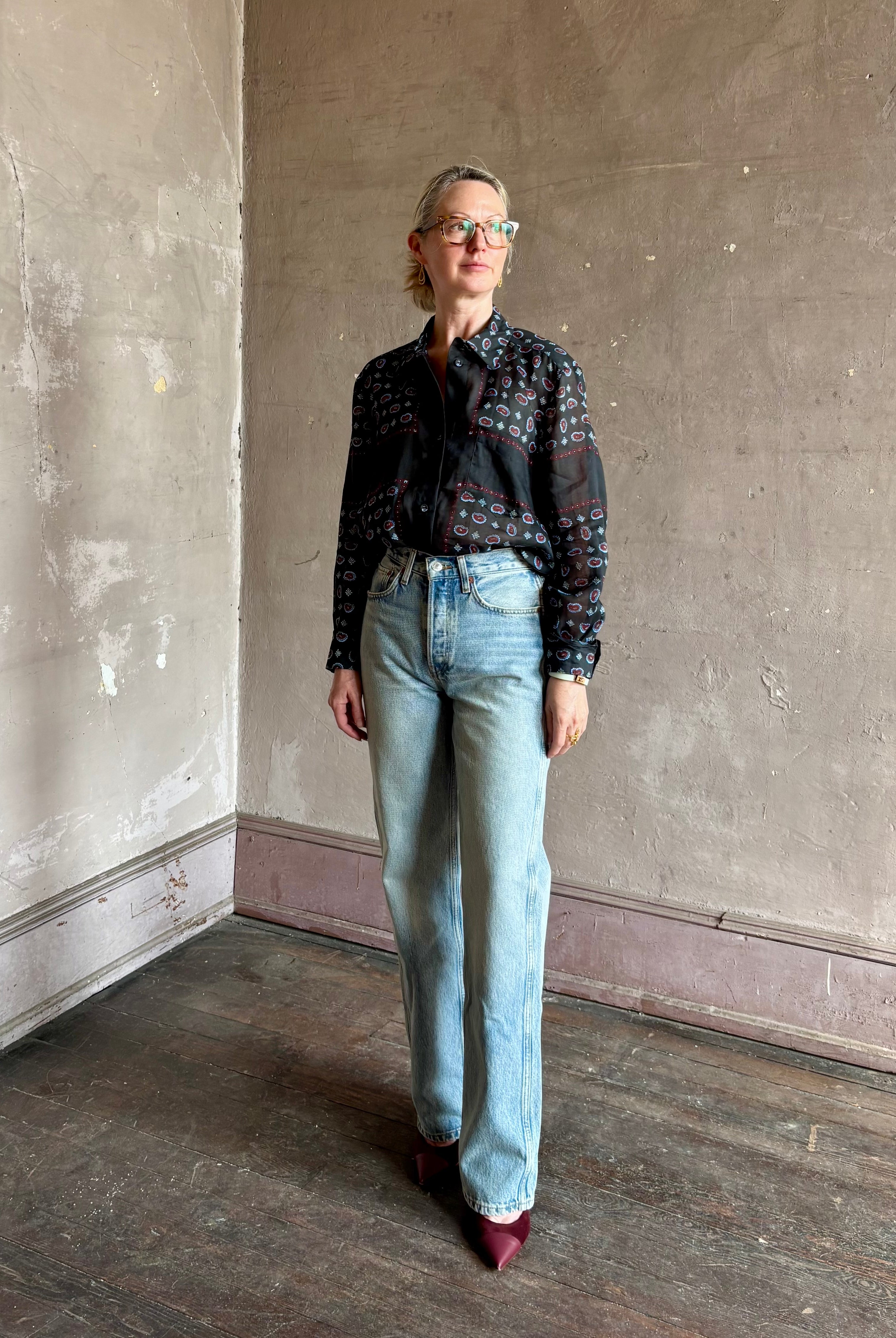 Mature woman wearing designer brand Rachel Comey long sleeve paisley print button down shirt semi-transparent