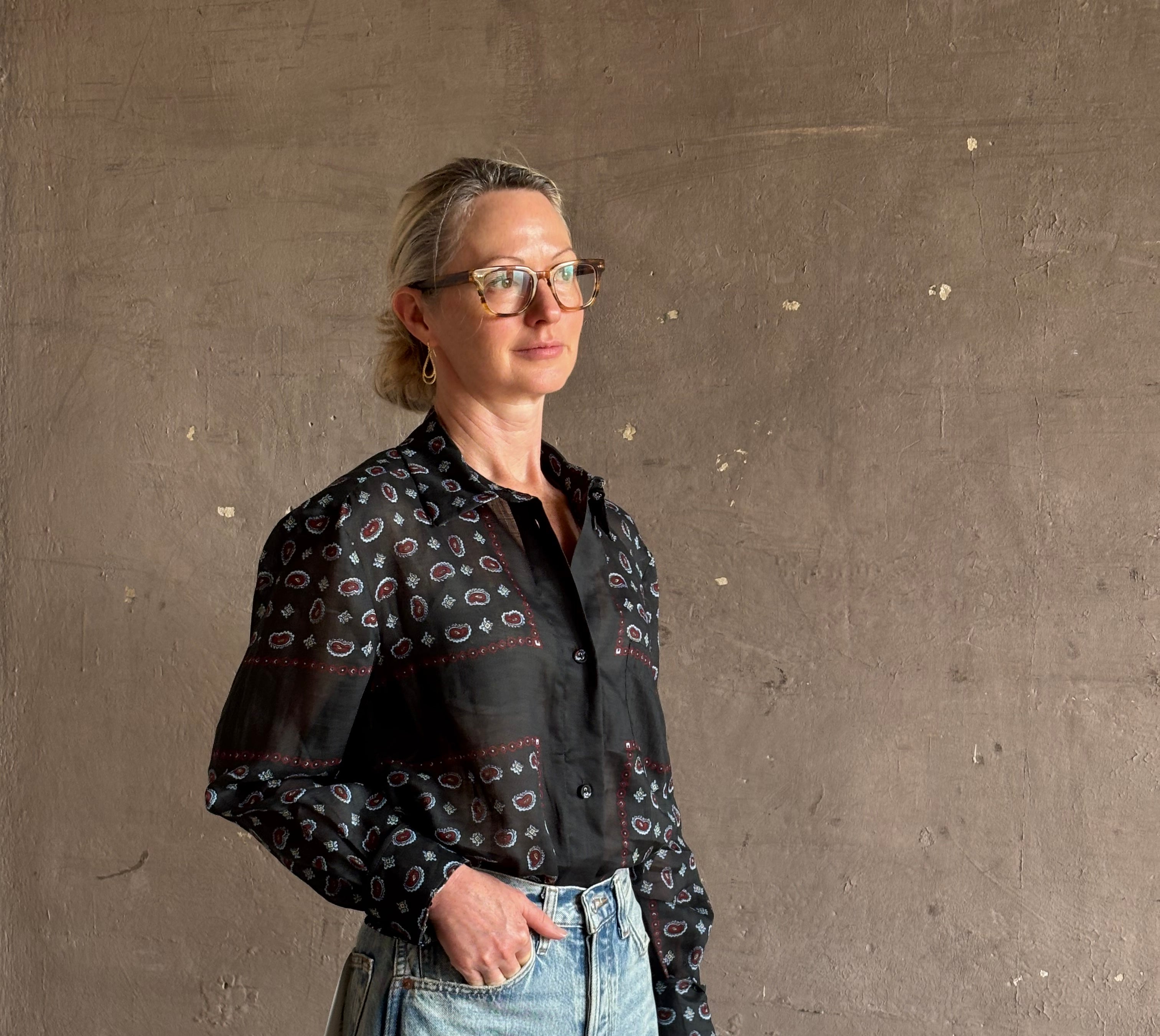 Mature woman wearing designer brand Rachel Comey long sleeve paisley print button down shirt semi-transparent