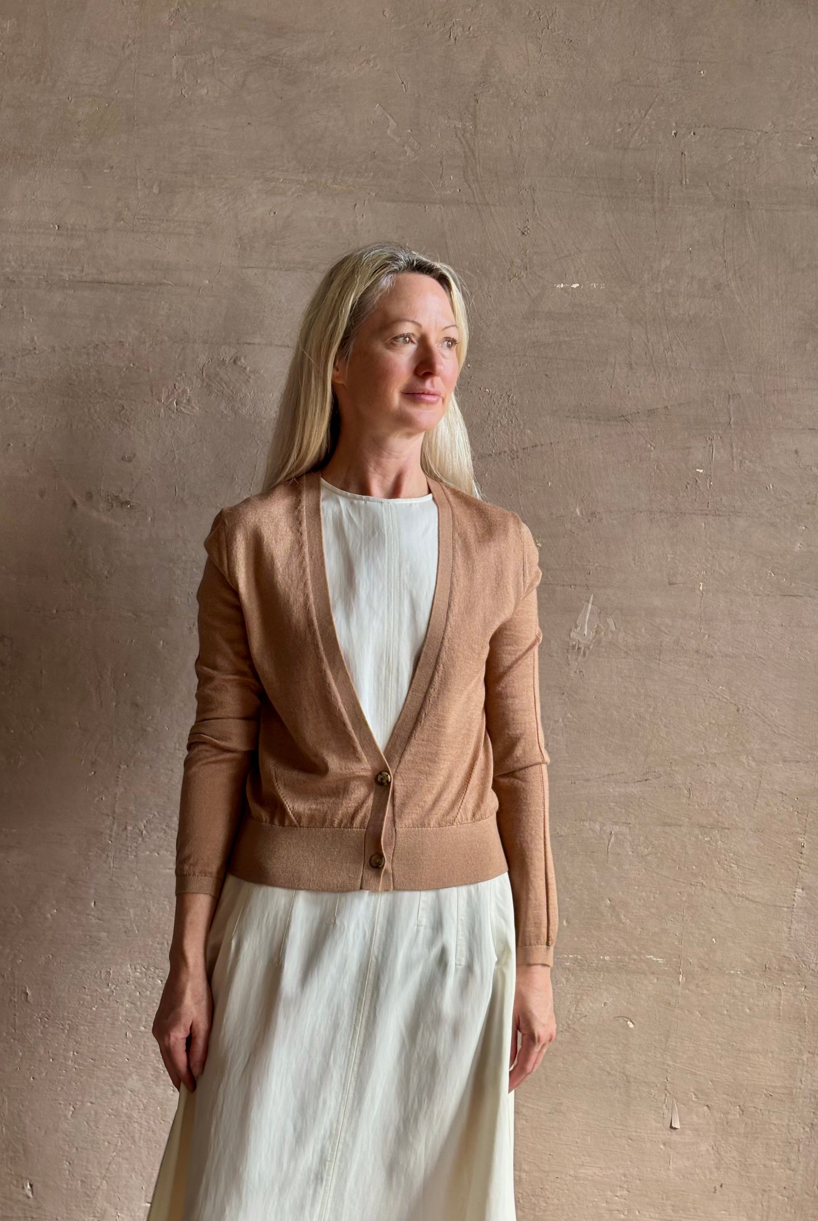 Mature woman wearing Rachel Comey long sleeve caramel cardigan leightweight plunging v-neck layering