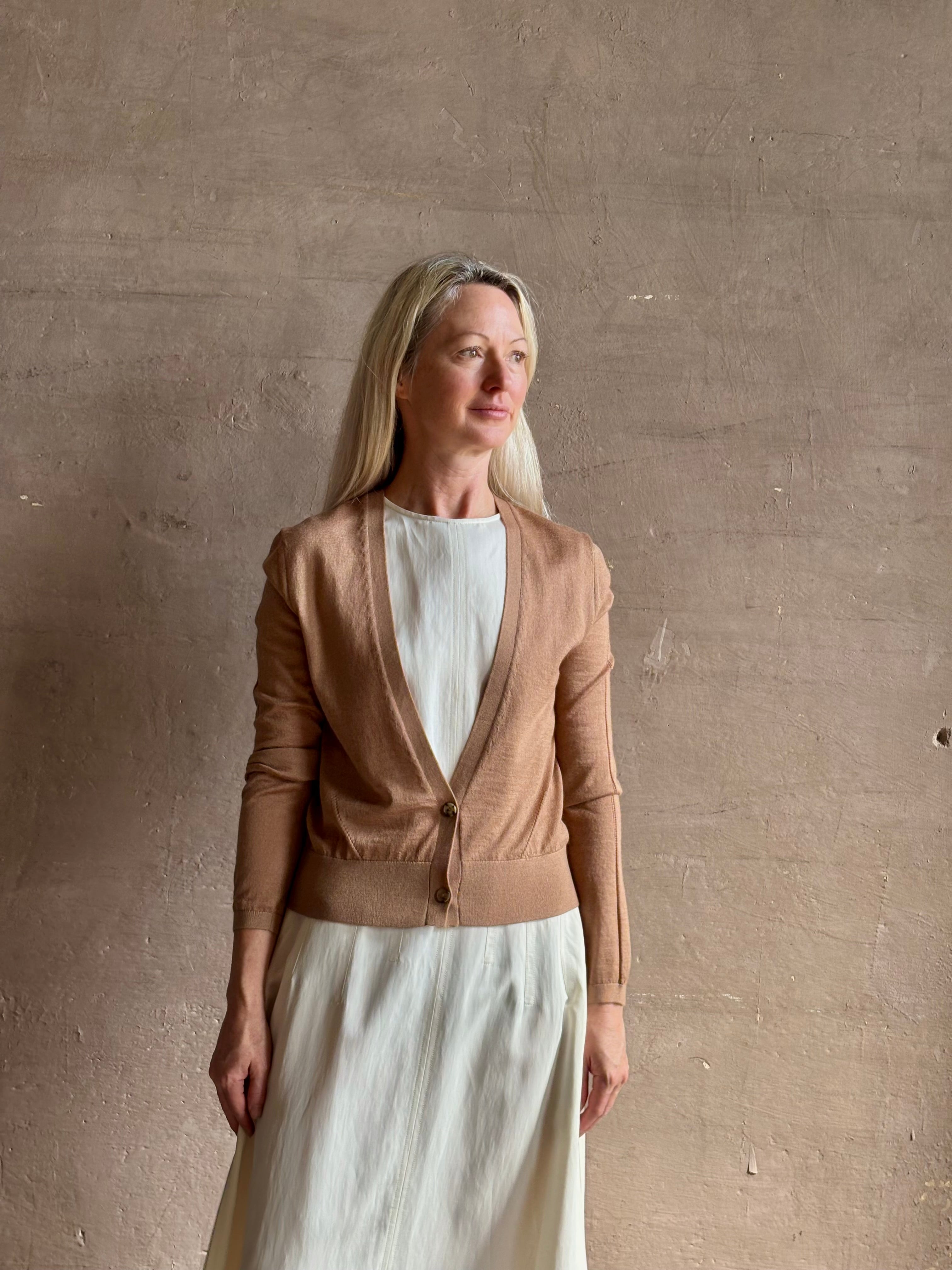Mature woman wearing Rachel Comey long sleeve caramel cardigan leightweight plunging v-neck layering