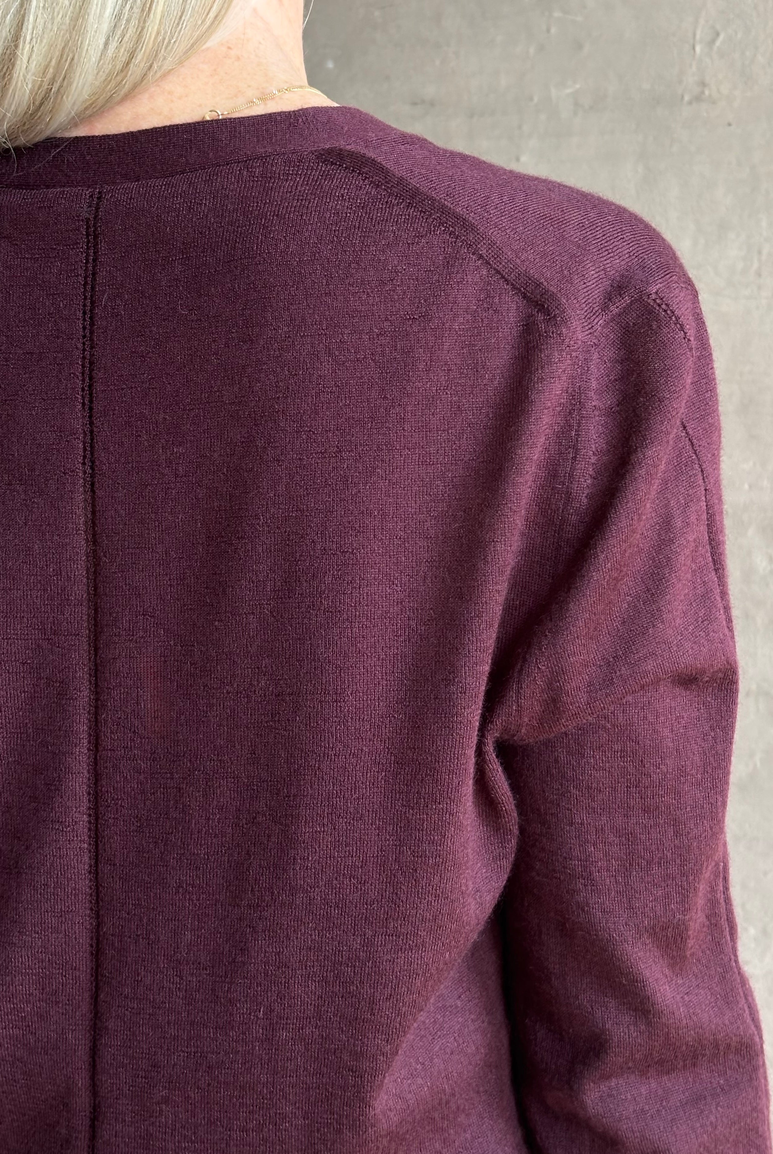 Mature woman wearing Rachel Comey long sleeve burgundy cardigan leightweight plunging v-neck layering
