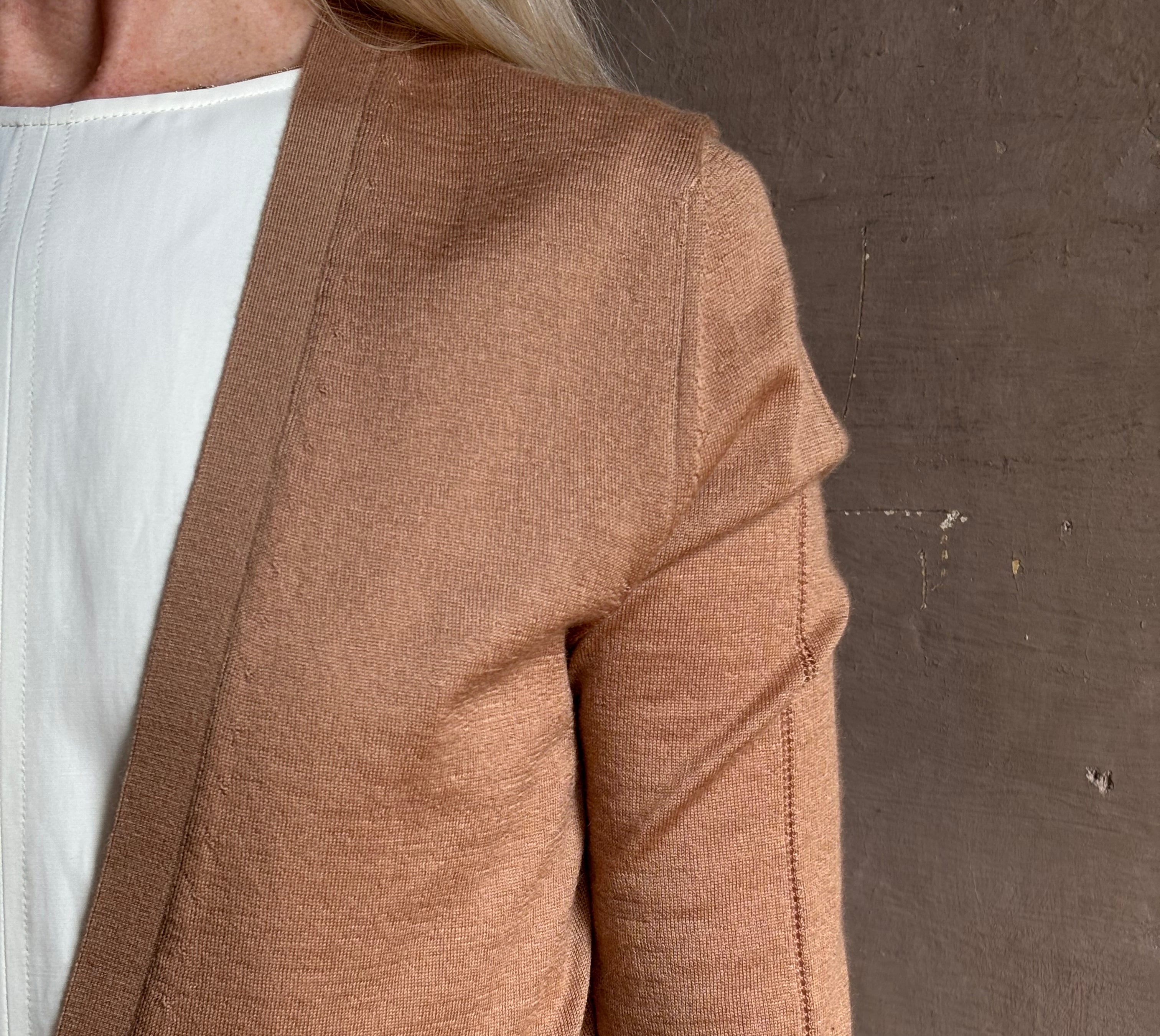 Mature woman wearing Rachel Comey long sleeve caramel cardigan leightweight plunging v-neck layering