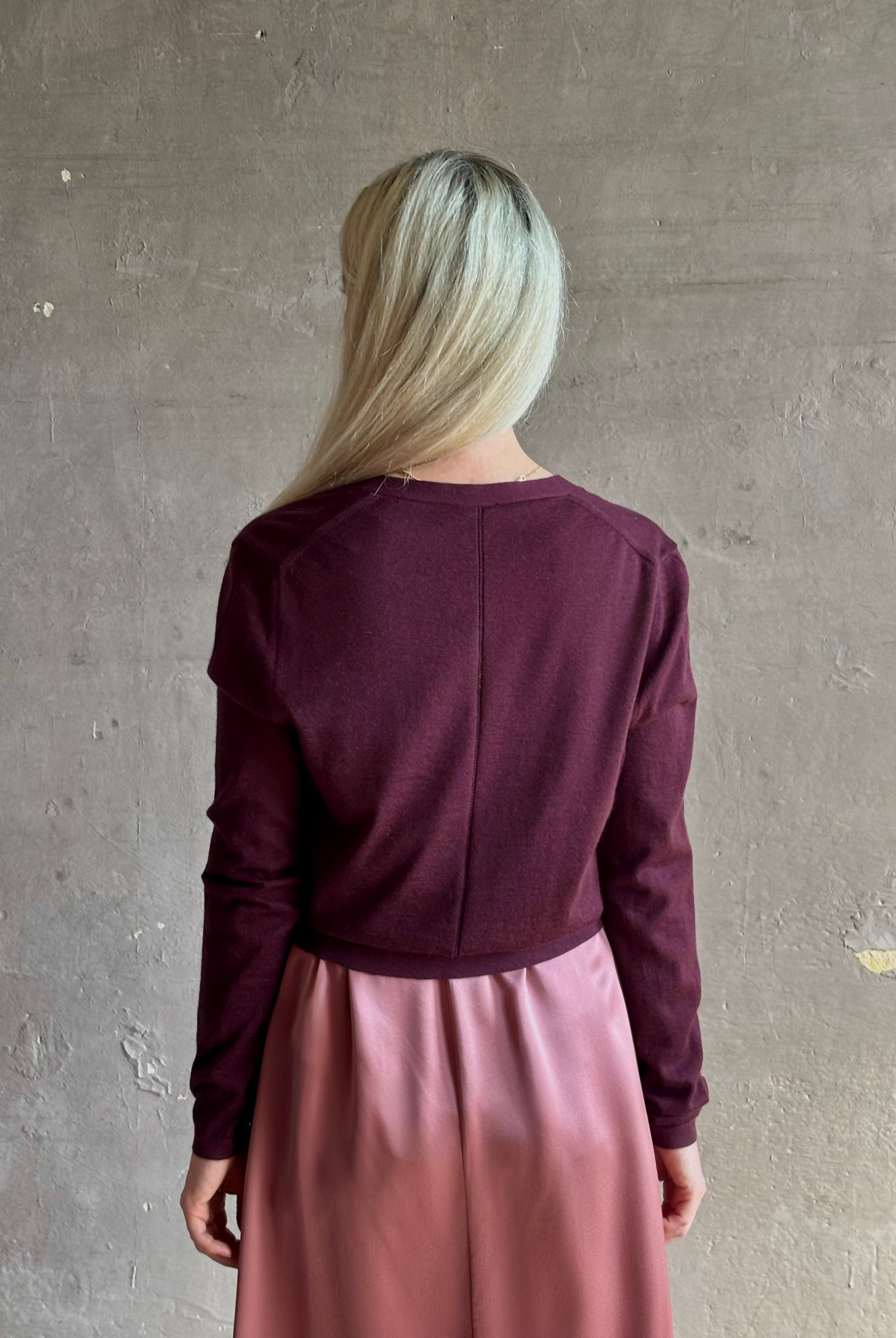 Mature woman wearing Rachel Comey long sleeve burgundy cardigan leightweight plunging v-neck layering