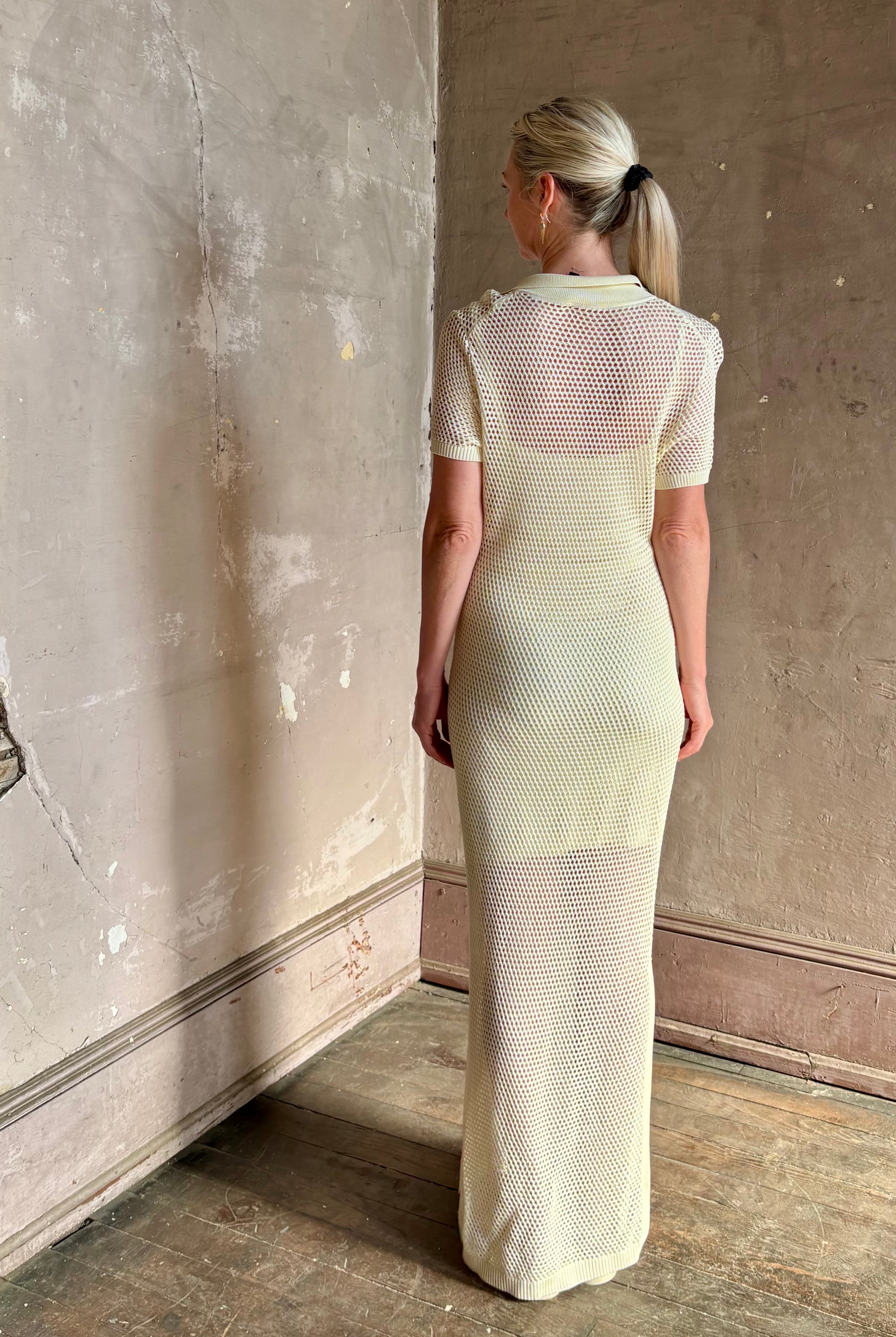 mature woman wearing Rag and bone Sheath cream maxi Dress open knit with slip slim-fit polo short sleeve side slits