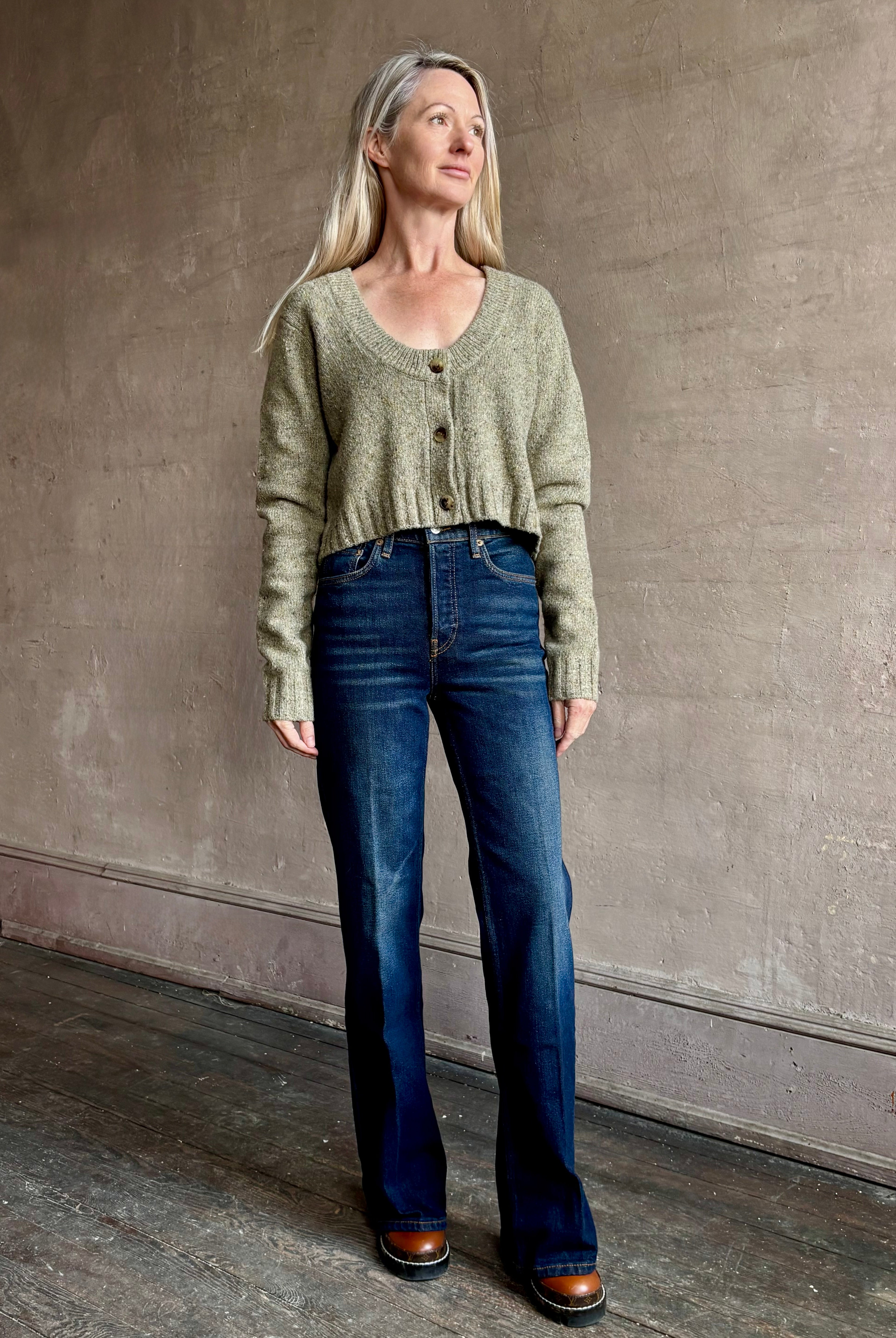 Woman wearing REDONE 70s Bootcut Denim in a dark blue wash with comfort stretch zip closure finished hem and 10.75" rise