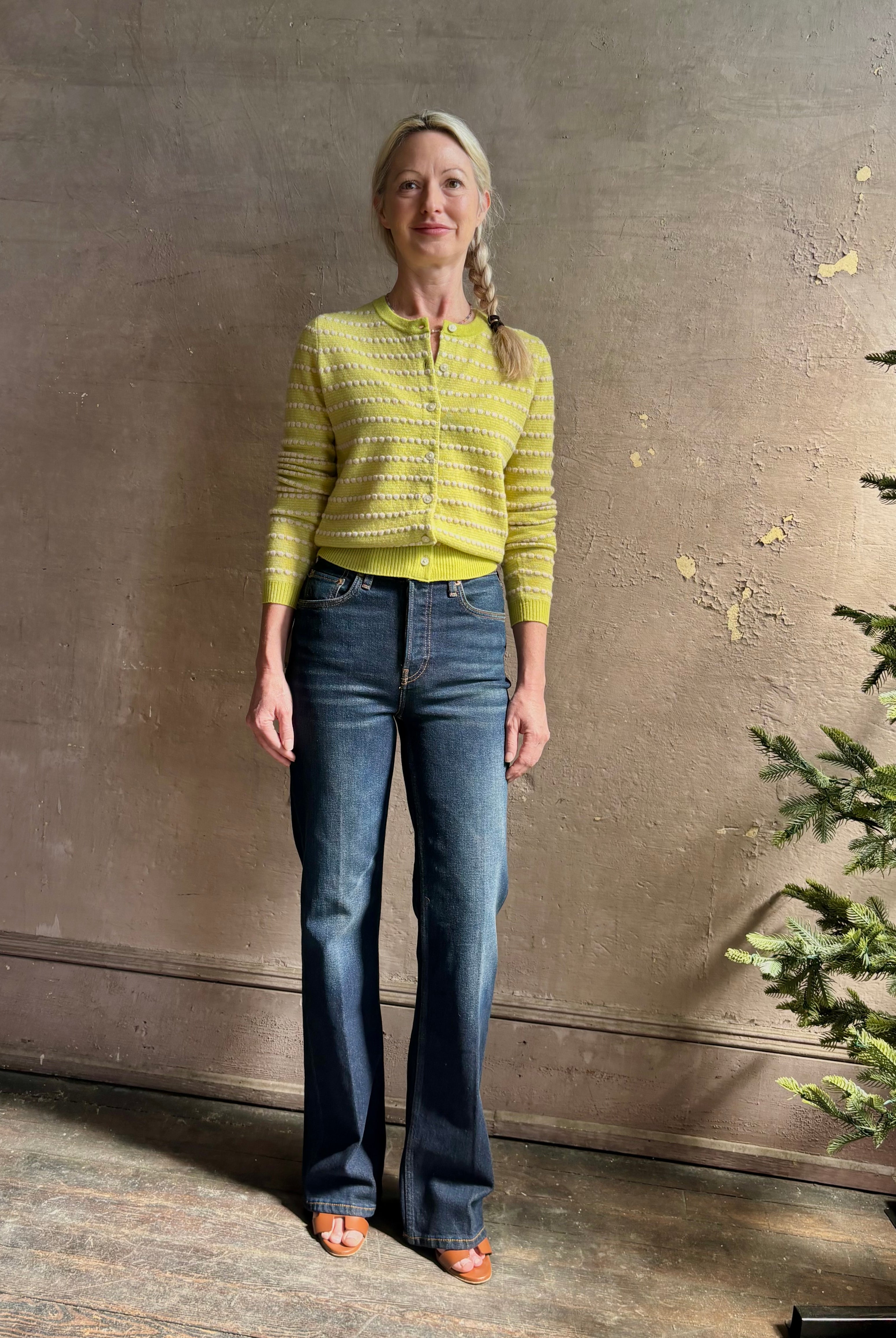 Woman wearing REDONE 70s Bootcut Denim in a dark blue wash with comfort stretch zip closure finished hem and 10.75" rise