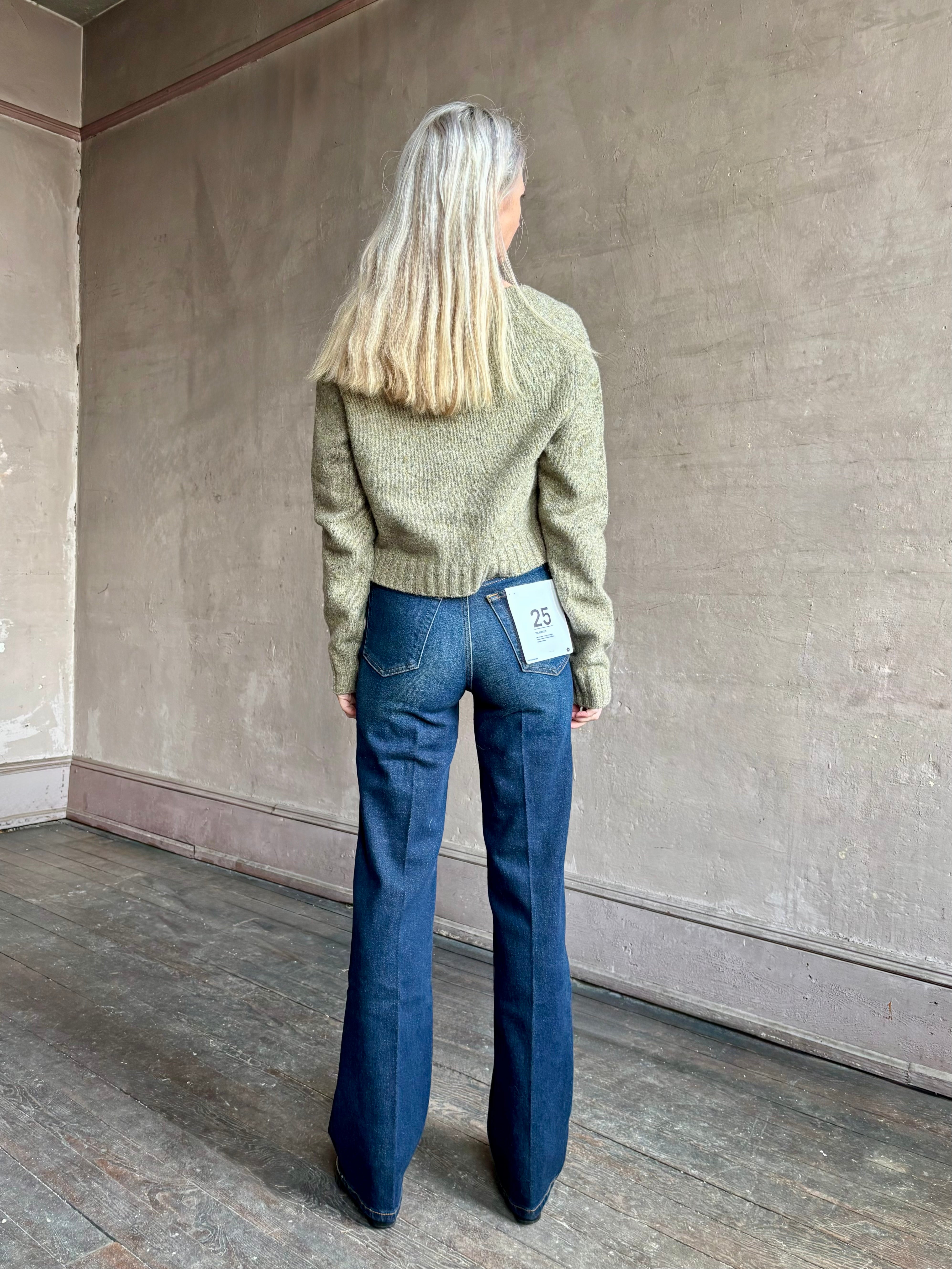 Woman wearing REDONE 70s Bootcut Denim in a dark blue wash with comfort stretch zip closure finished hem and 10.75" rise