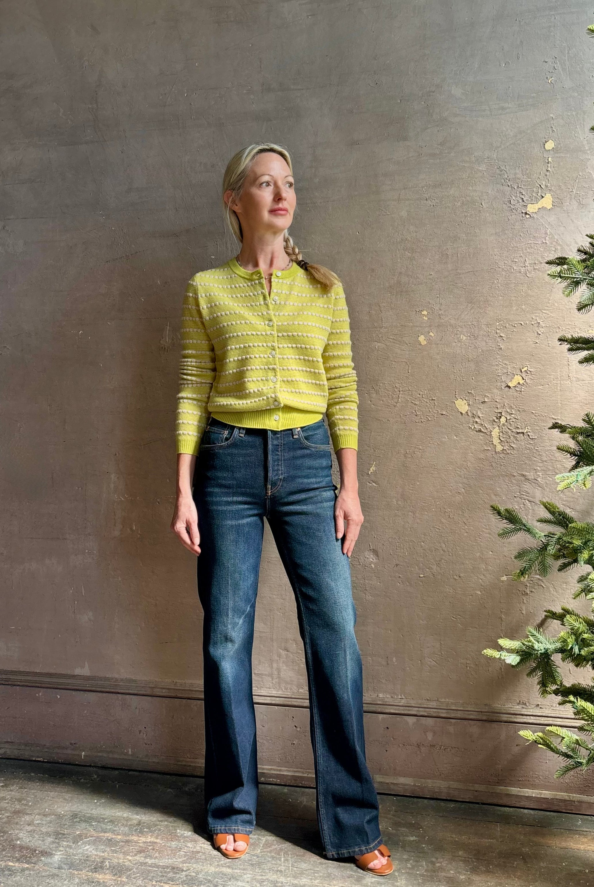 Woman wearing REDONE 70s Bootcut Denim in a dark blue wash with comfort stretch zip closure finished hem and 10.75" rise