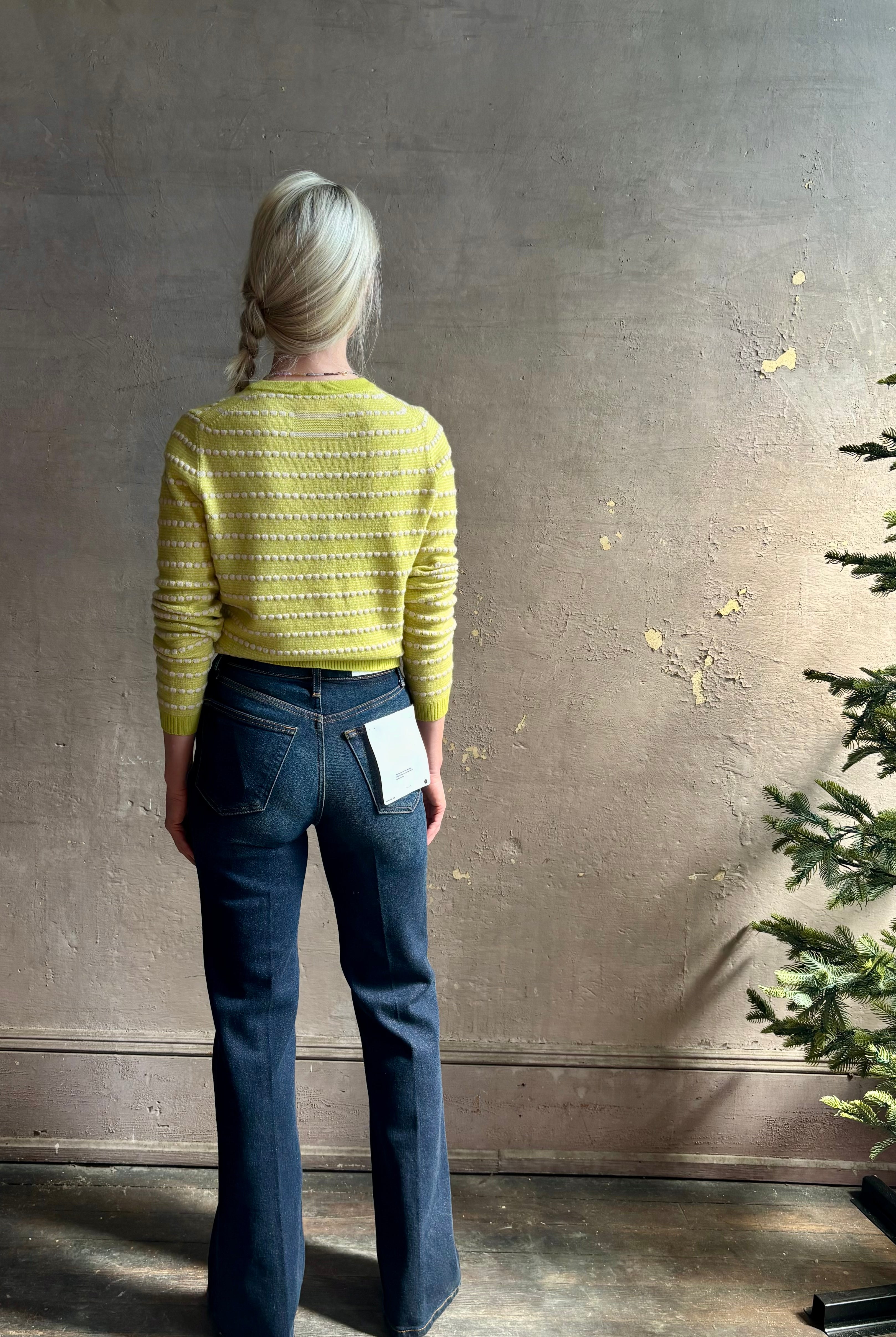 Woman wearing REDONE 70s Bootcut Denim in a dark blue wash with comfort stretch zip closure finished hem and 10.75" rise