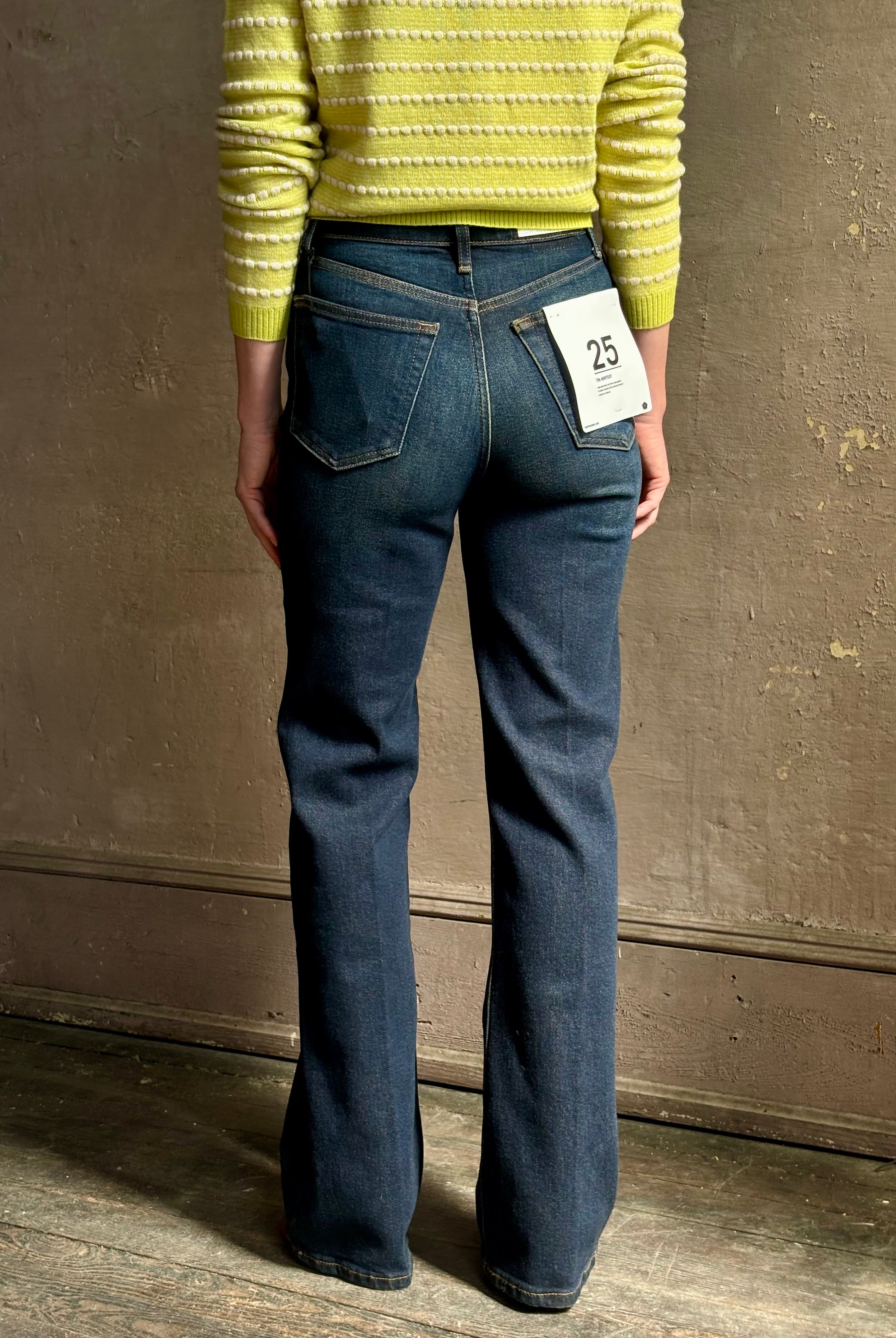 Woman wearing REDONE 70s Bootcut Denim in a dark blue wash with comfort stretch zip closure finished hem and 10.75" rise