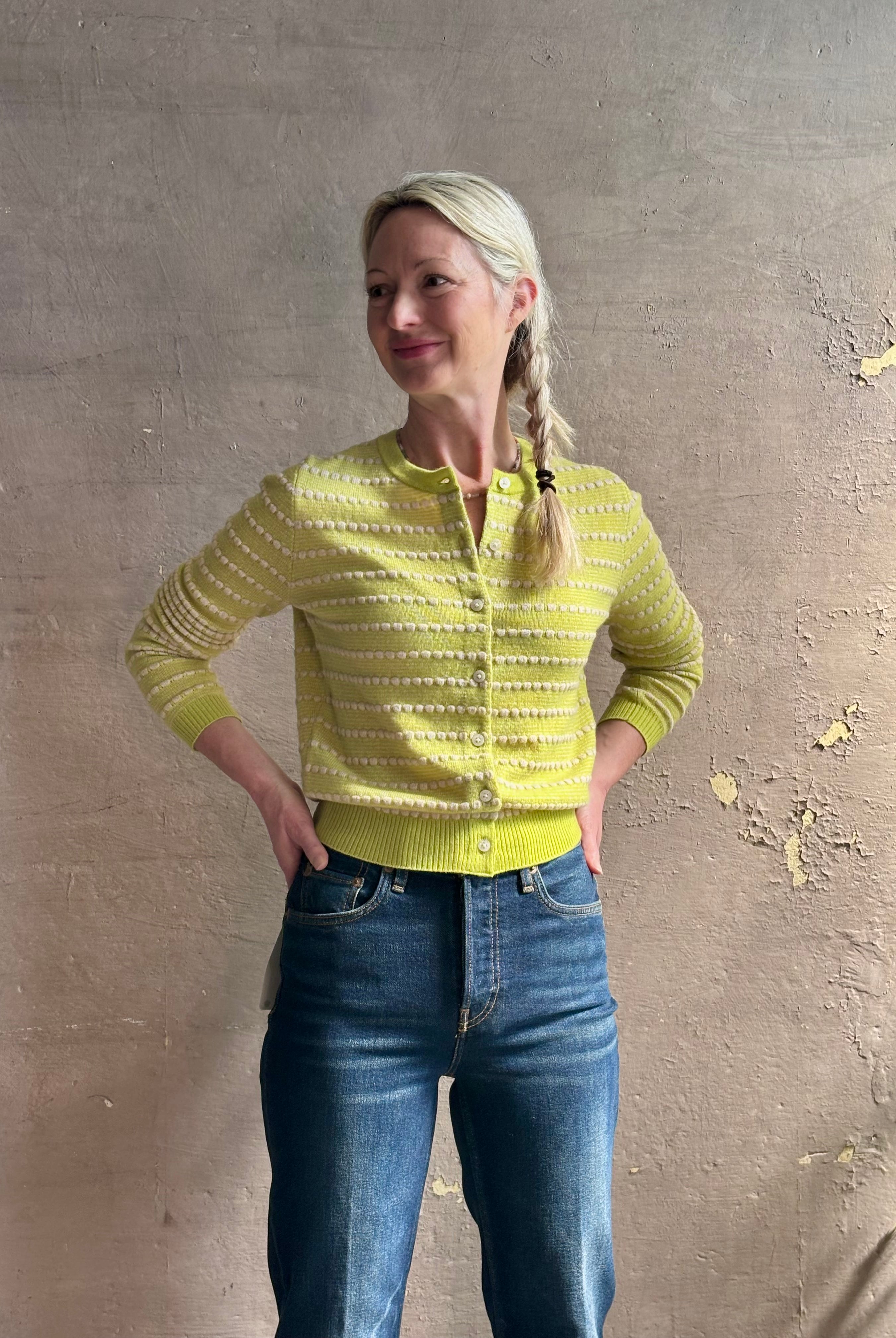 Woman wearing REDONE 70s Bootcut Denim in a dark blue wash with comfort stretch zip closure finished hem and 10.75" rise