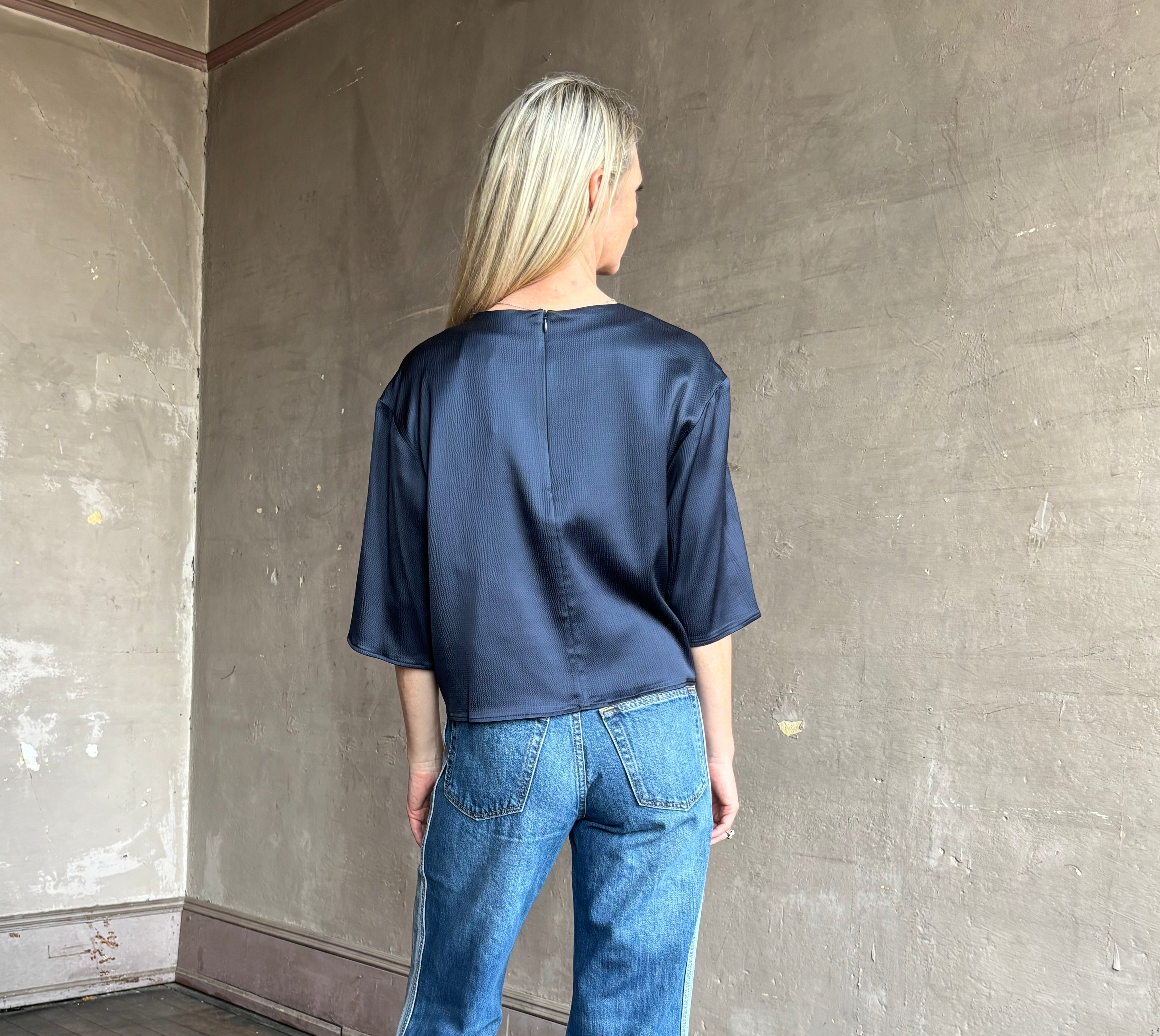 Image of mature woman wearing mid-rise jean ReDone track Californian denim with light blue stripe down side in Viper blue wash