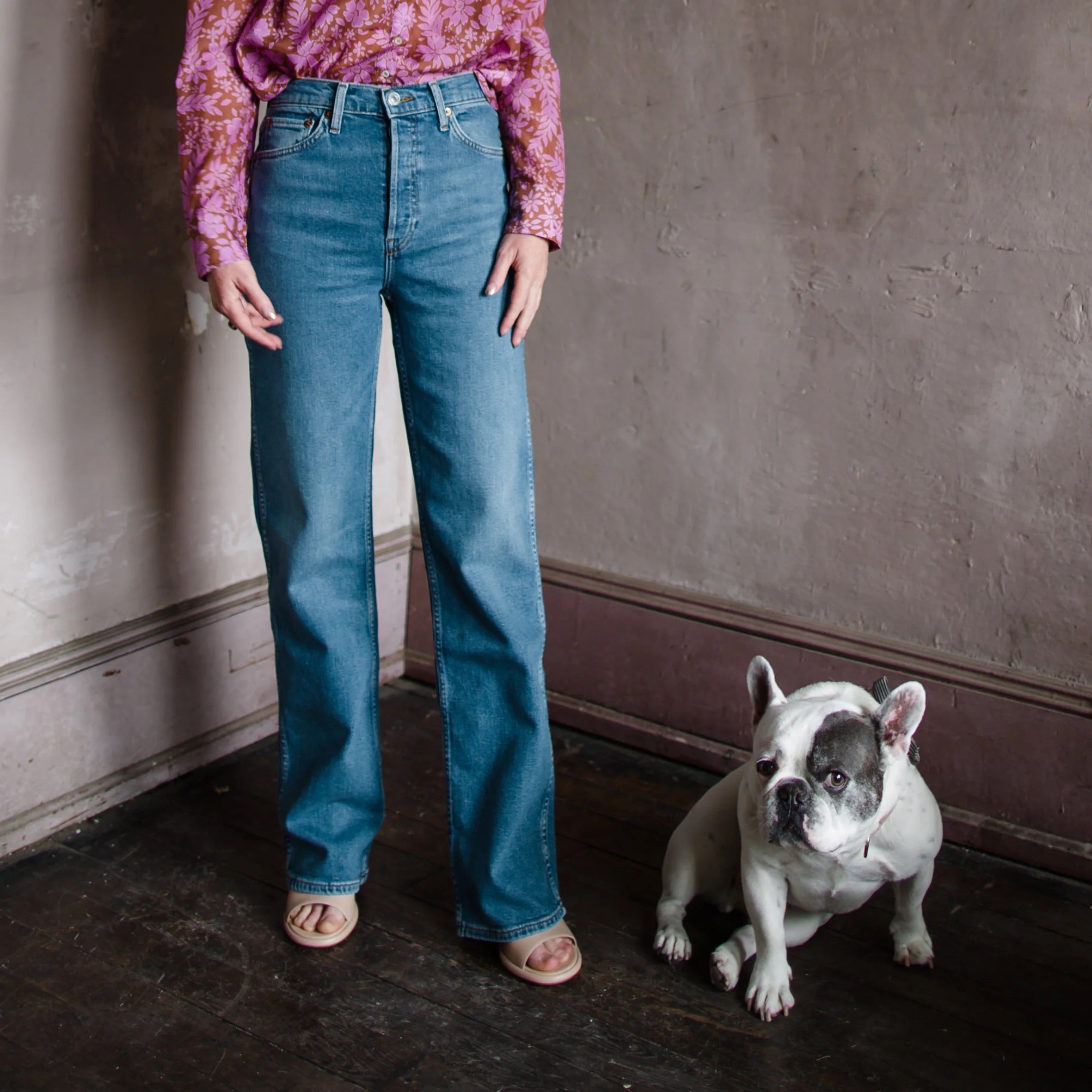 Mature woman wearing Re/Done 90s High Rise Loose aged indigo wash in stretch denim with button fly and finished hem