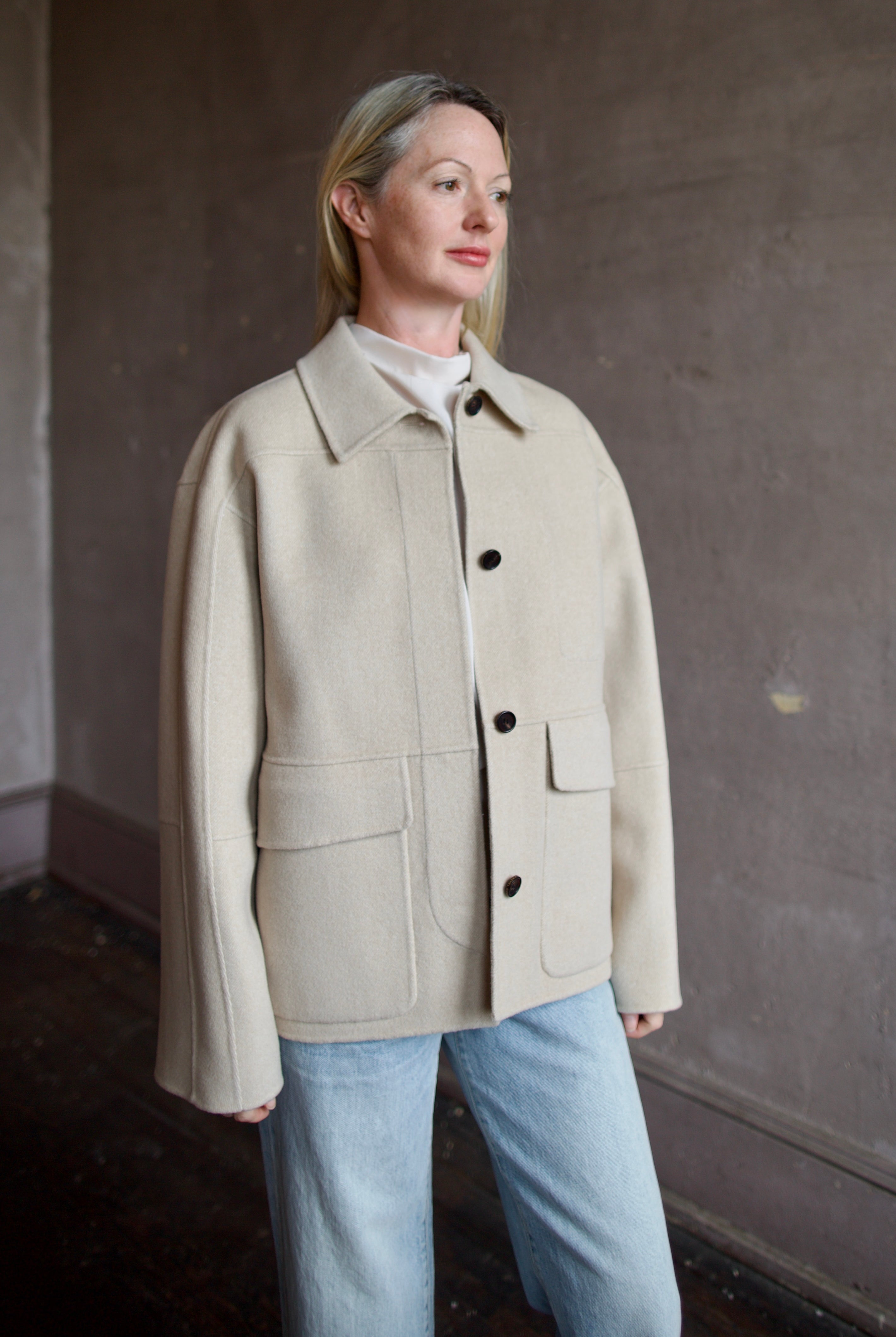 Model wearing a timeless beige cashmere coat by Rachel Comey