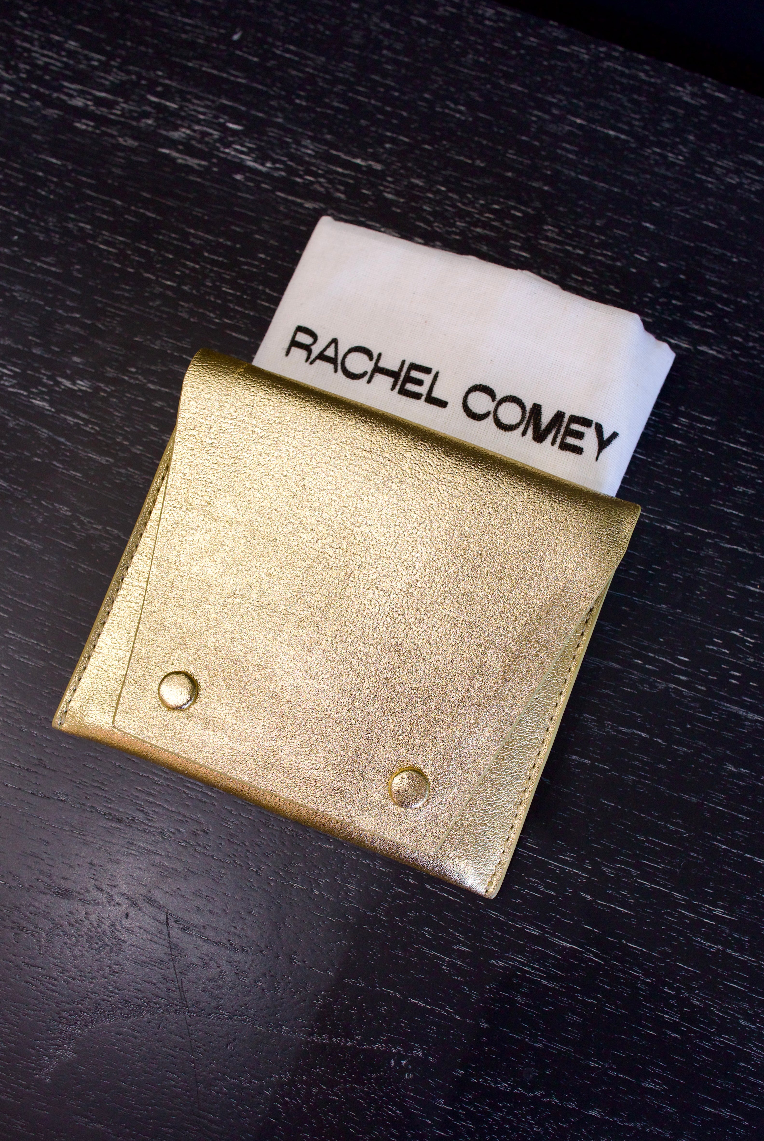 Metallic gold Rachel Comey leather wallet with two snap buttons closure