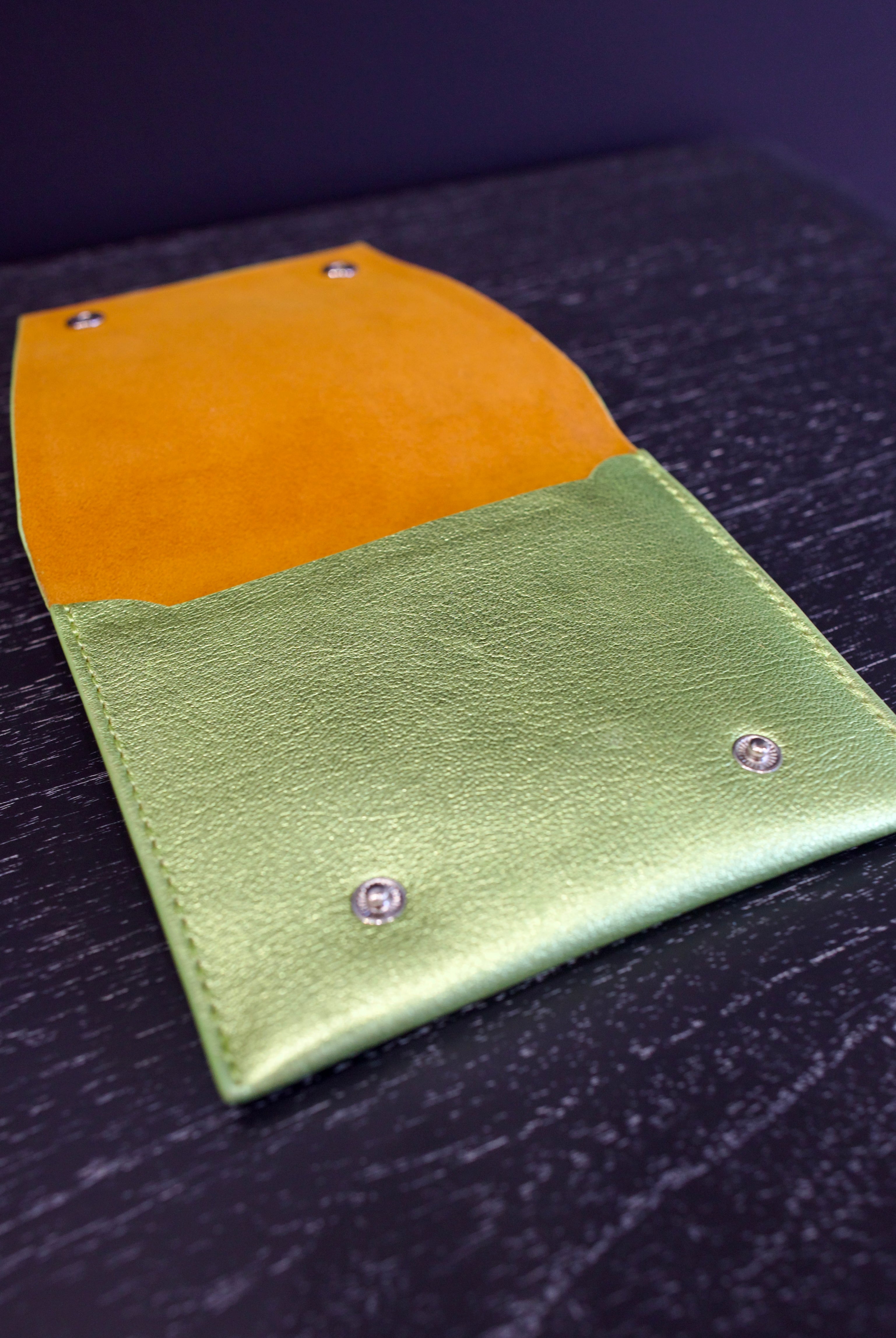 Open lime green Rachel Comey leather wallet with two snap buttons closure