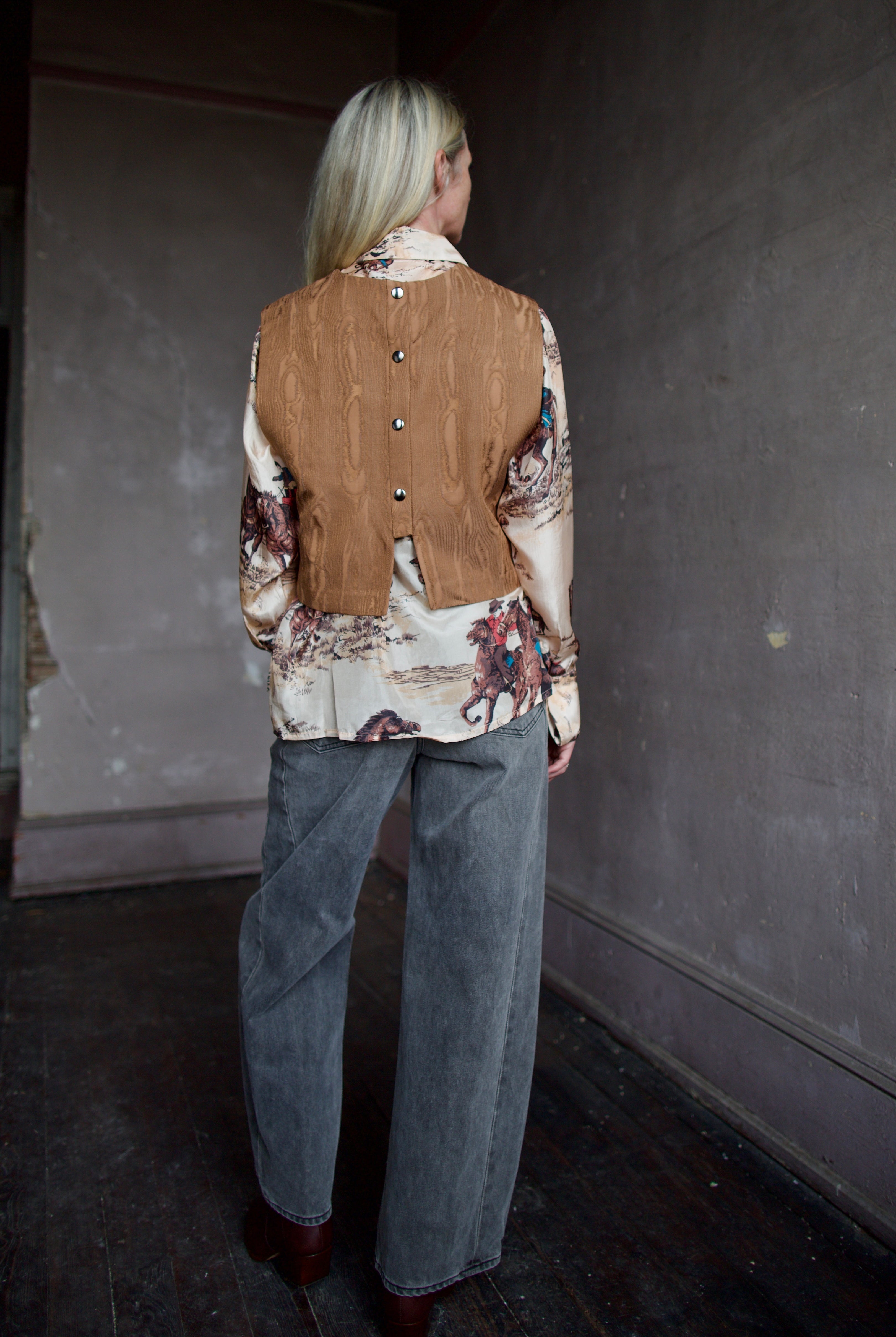 Model wearing a brown faux boise patterned top by designer Rachel Comey layered over a button down