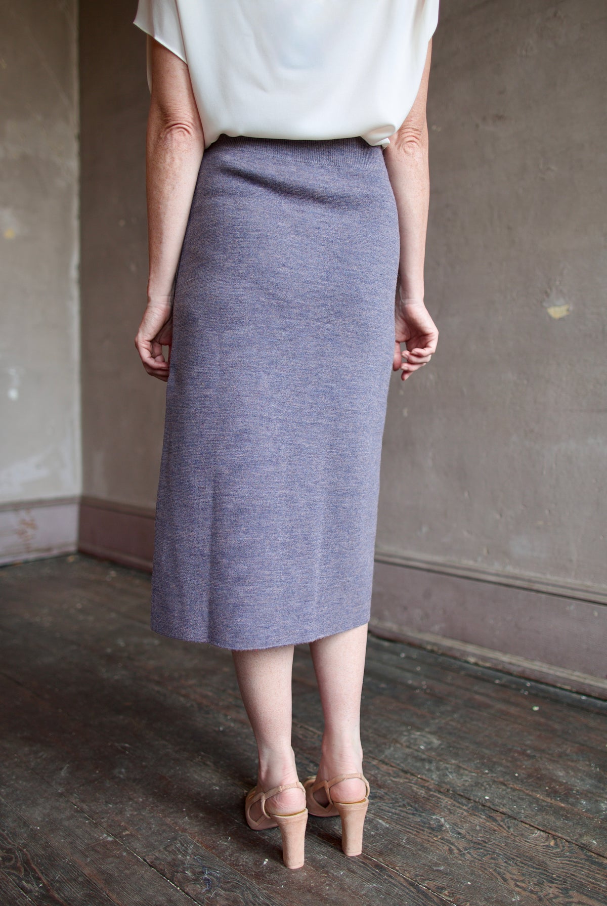 Mature model wearing a quality lilac knit skirt fabricated from baby alpaca by designer Rachel Comey