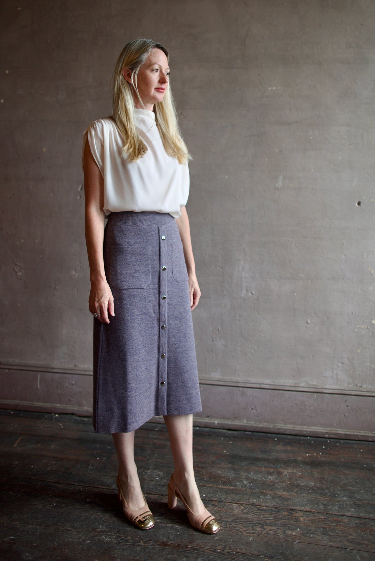 Mature model wearing a quality lilac knit skirt fabricated from baby alpaca by designer Rachel Comey