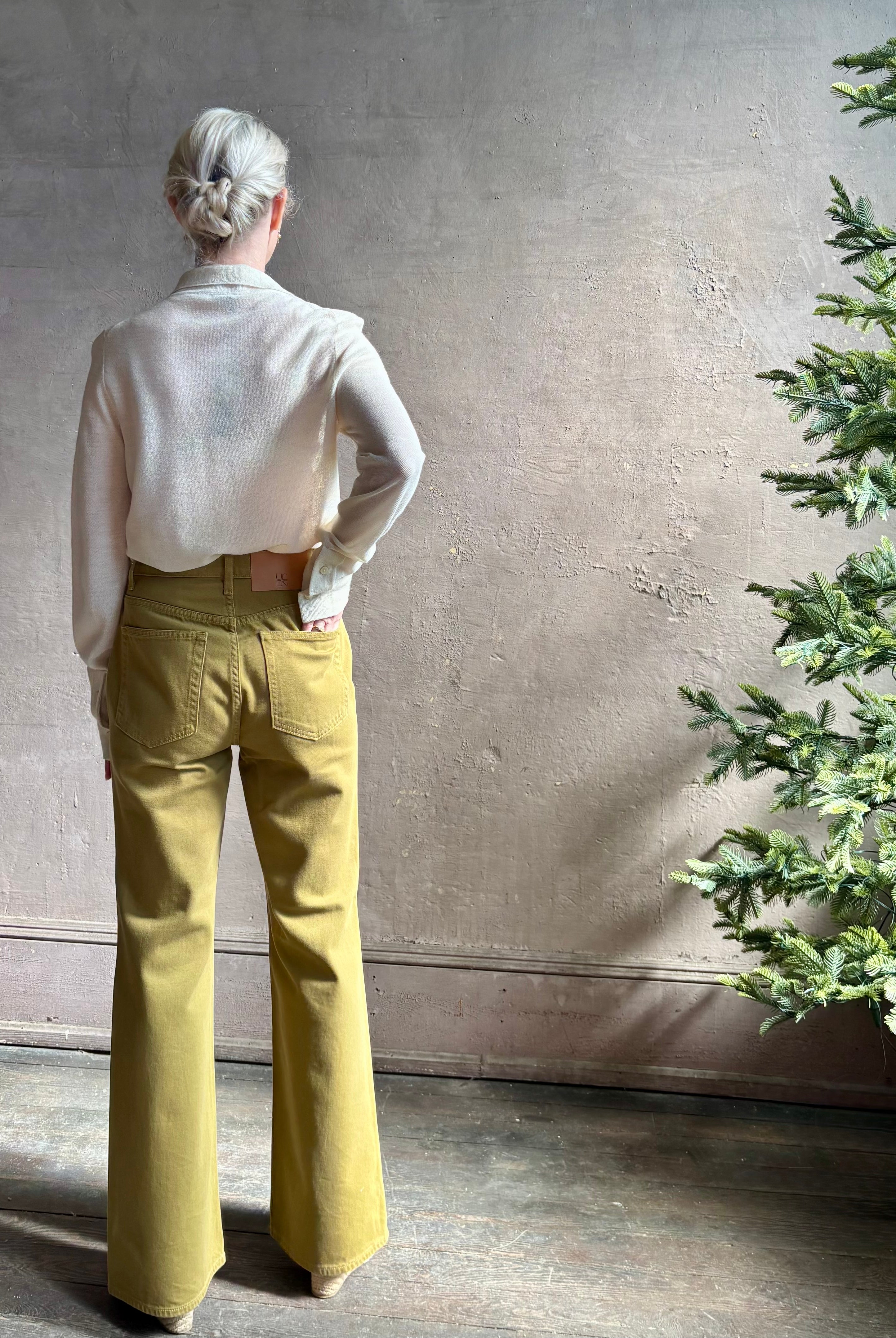 Mature woman wearing Premium Baby Alpaca Mulberry Silk Calma shirt by Rachel Comey with button front, long sleeves and collar rendered in cream