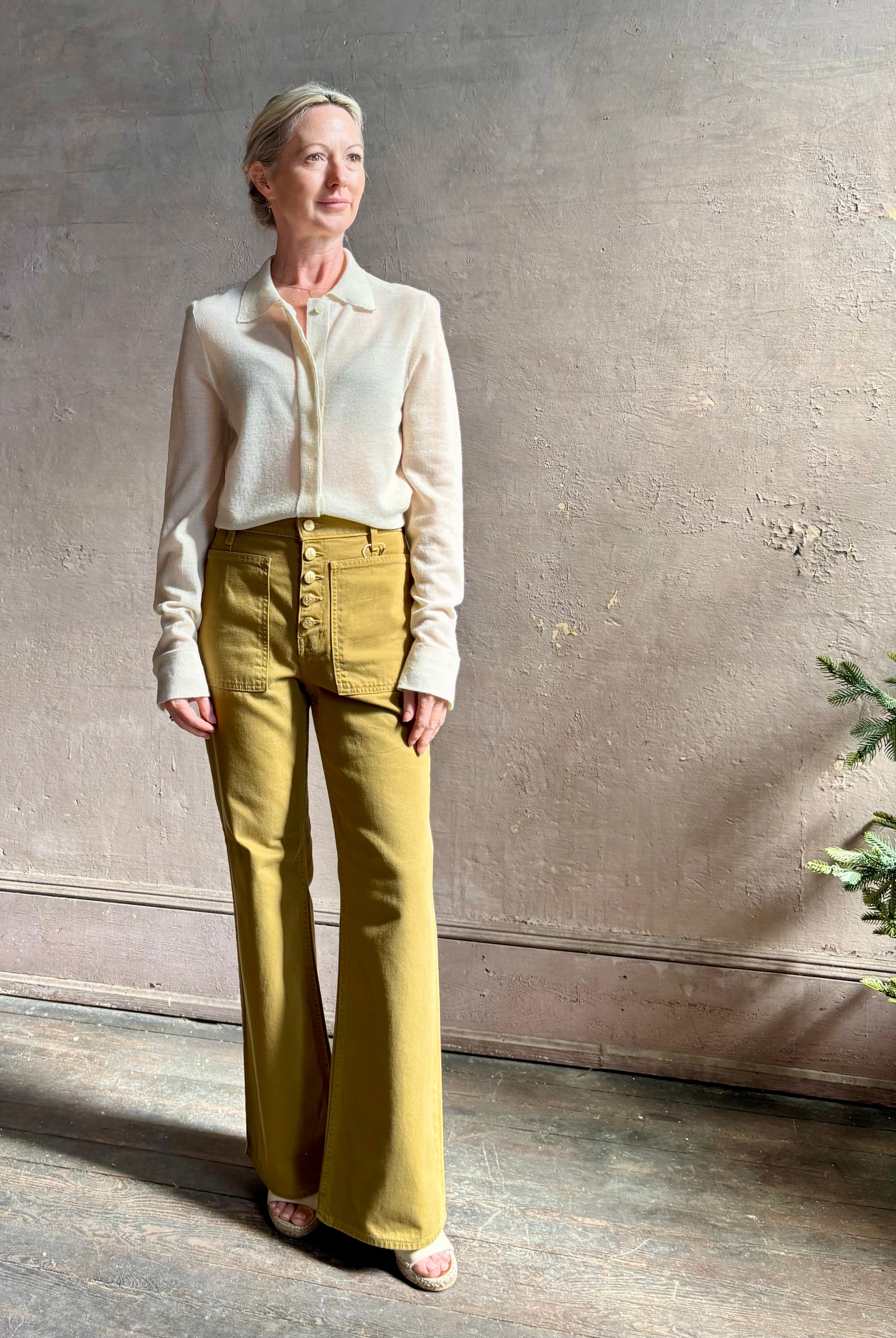 Mature woman wearing Premium Baby Alpaca Mulberry Silk Calma shirt by Rachel Comey with button front, long sleeves and collar rendered in cream