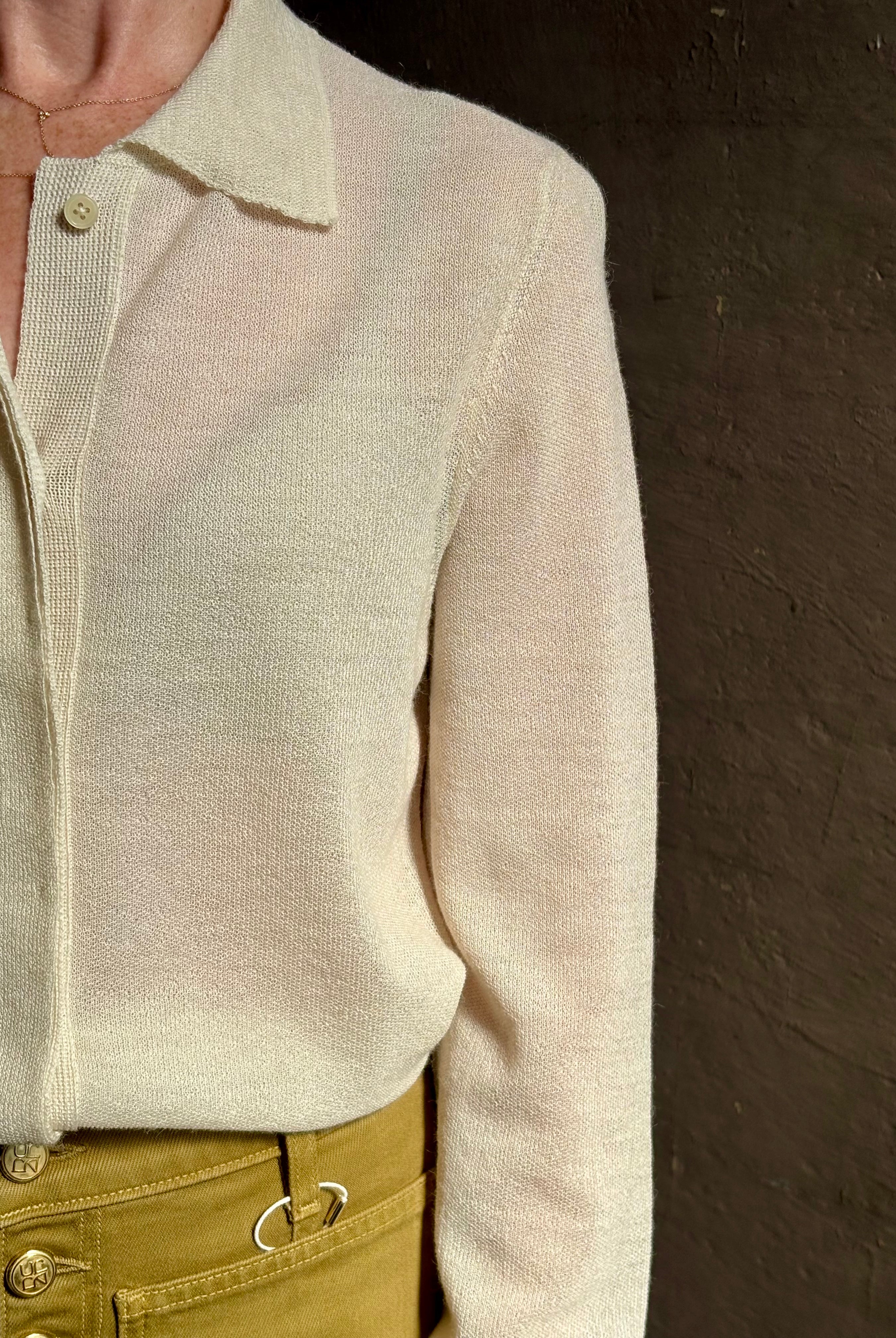 Mature woman wearing Premium Baby Alpaca Mulberry Silk Calma shirt by Rachel Comey with button front, long sleeves and collar rendered in cream