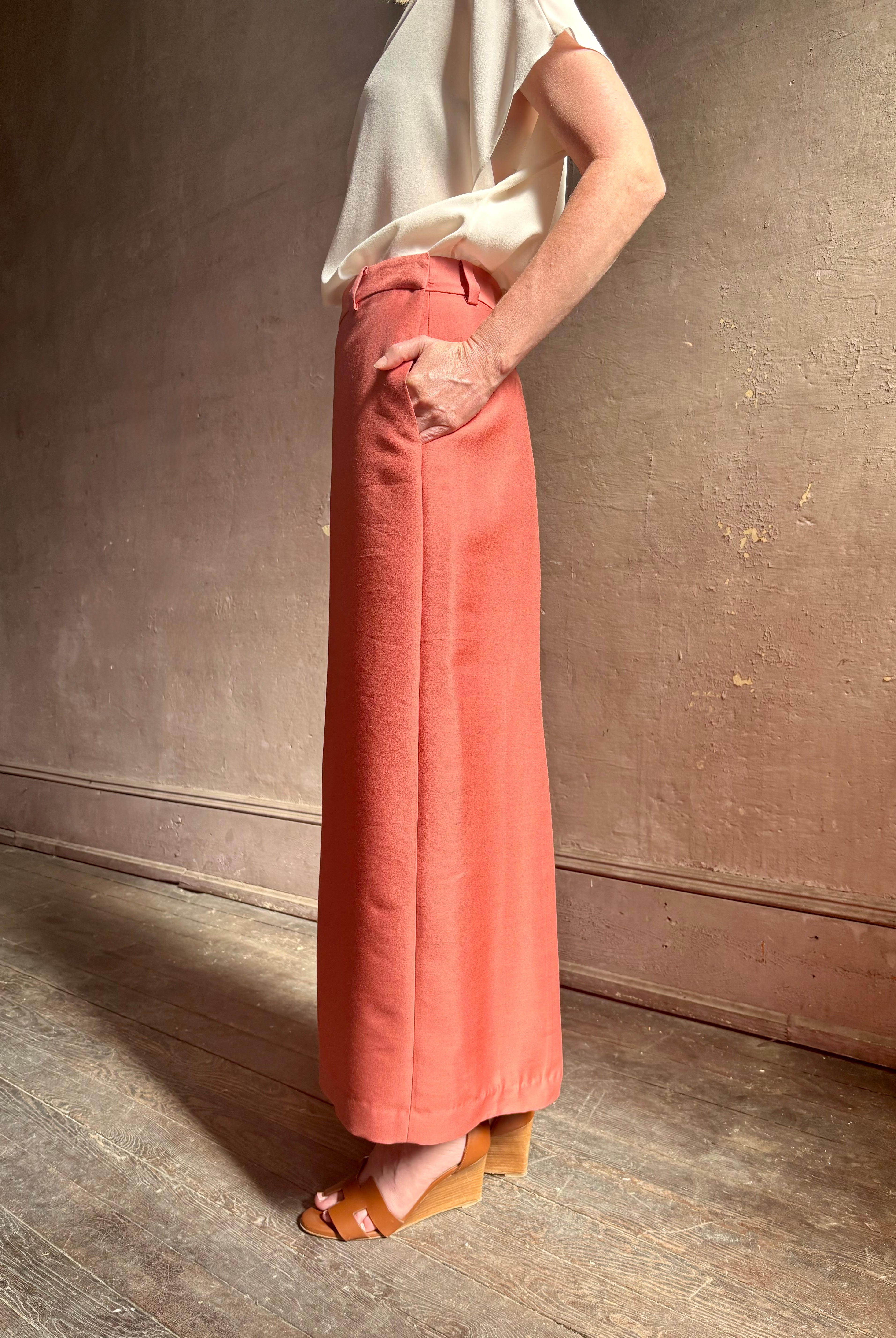Mature woman wearing premium wool silk women's designer Rachel Comey Cosa maxi Skirt with tailored waistband, belt loops and back vent rendered in a vibrant warm pink hue