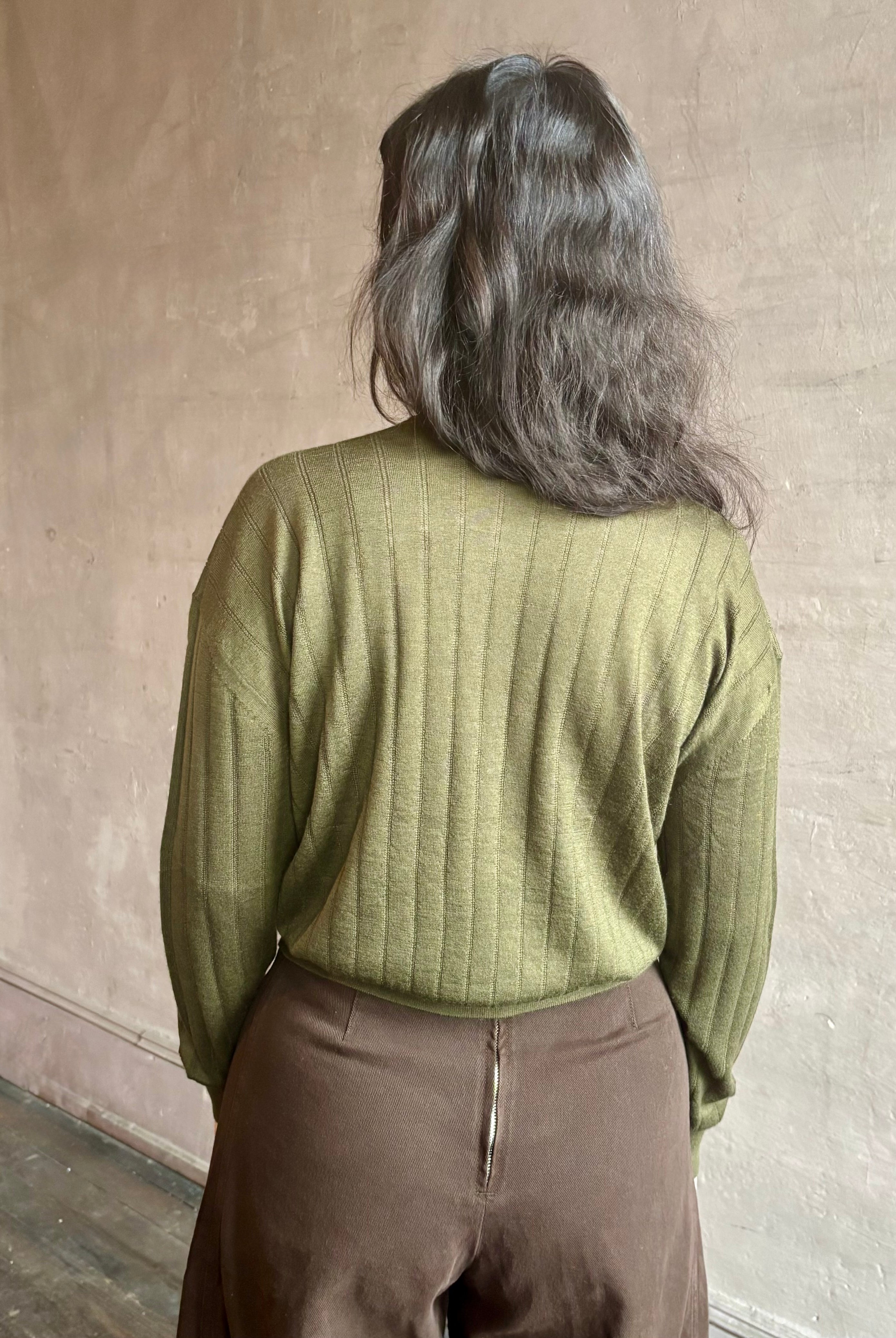 Image of woman wearing luxury Cashmere Silk Marion V-Neck designer Sweater by Rachel Comey in olive green with long sleeves and linear weave