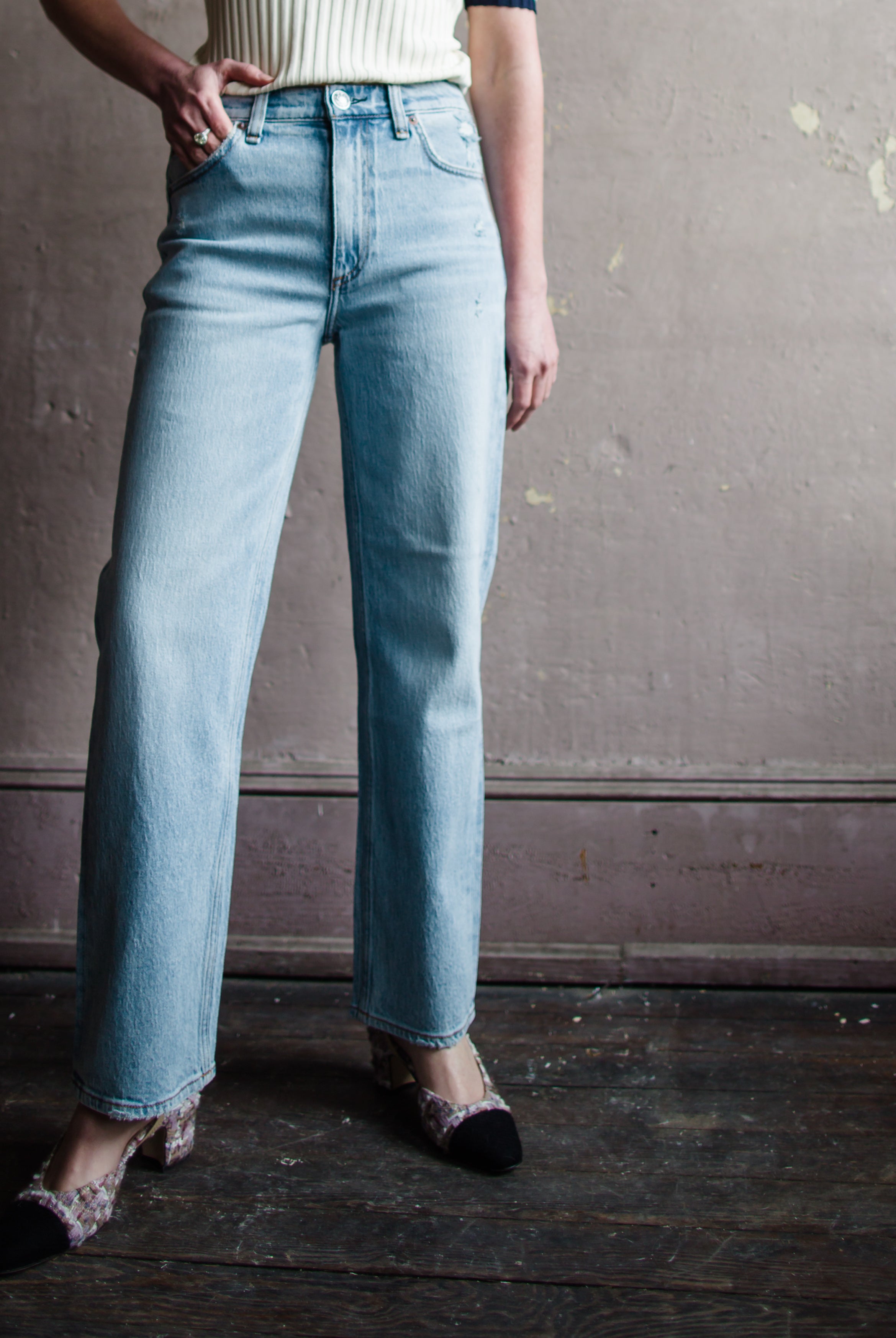 Image featuring a woman wearing  Rag & Bone Harlow denim with straight leg, mid-rise style that's fitted through the thigh crafted from stretch denim, ankle length jean.
