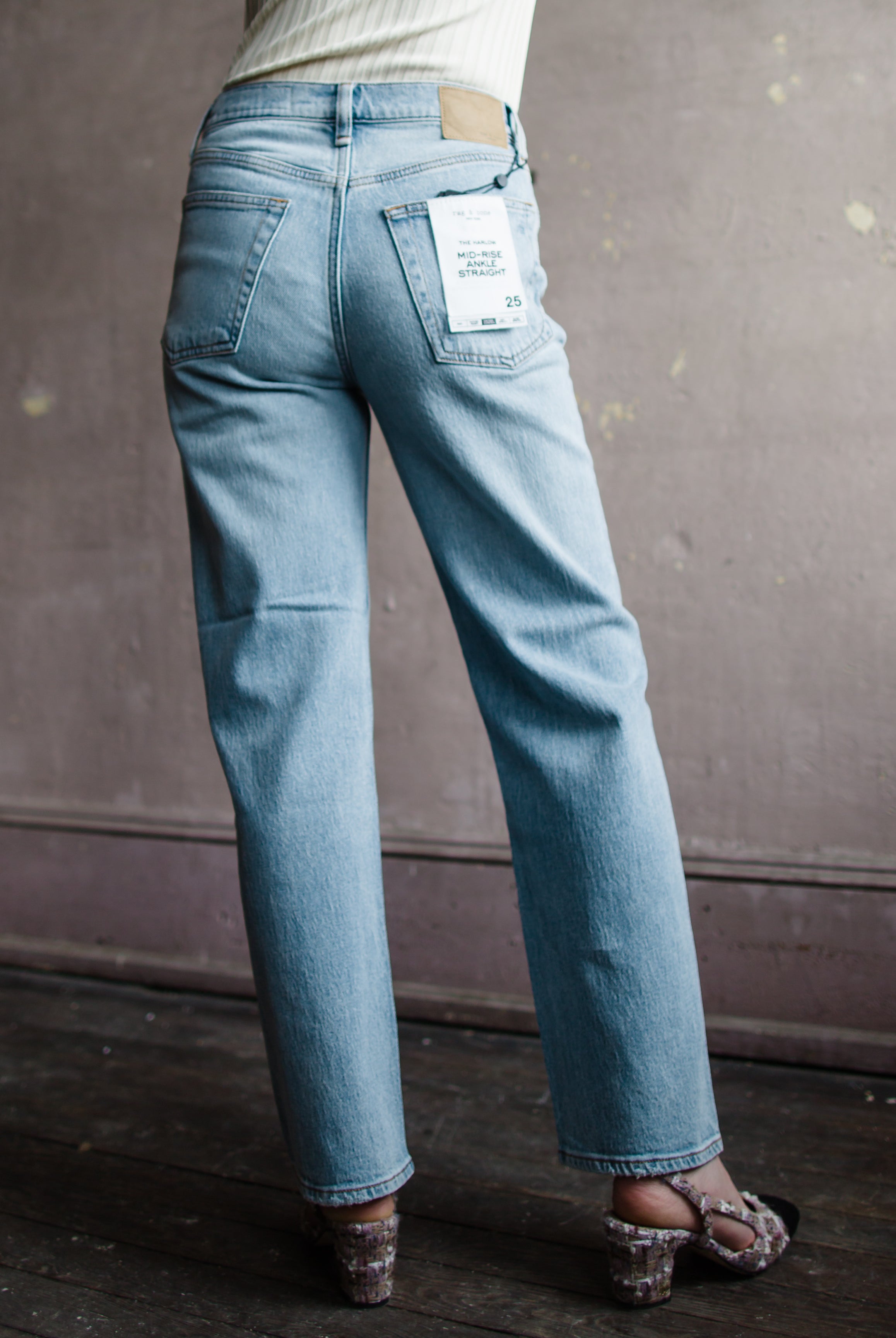 Image featuring a woman wearing  Rag & Bone Harlow denim with straight leg, mid-rise style that's fitted through the thigh crafted from stretch denim, ankle length jean.