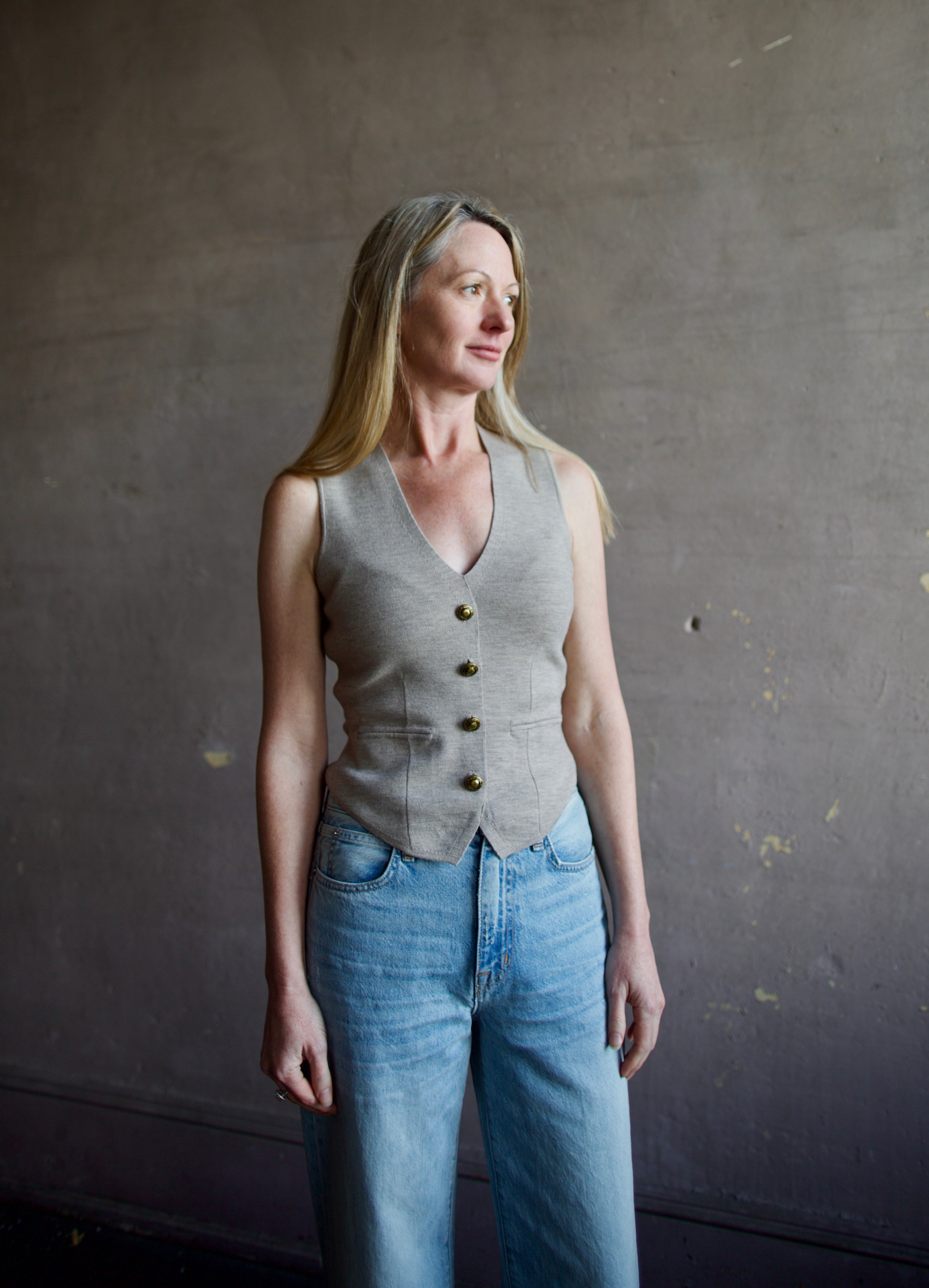 Mature woman wearing advanced contemporary Women's Rag and Bone Ella Vest in dark taupe offers a sophisticated layering in fitted knit