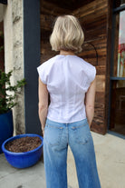 Woman wearing the Rag and Bone Ines luxury women's cotton  poplin top featuring deep V neckline with seam detailing to an elevated basic