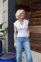 Woman wearing the Rag and Bone Ines luxury women's cotton  poplin top featuring deep V neckline with seam detailing to an elevated basic