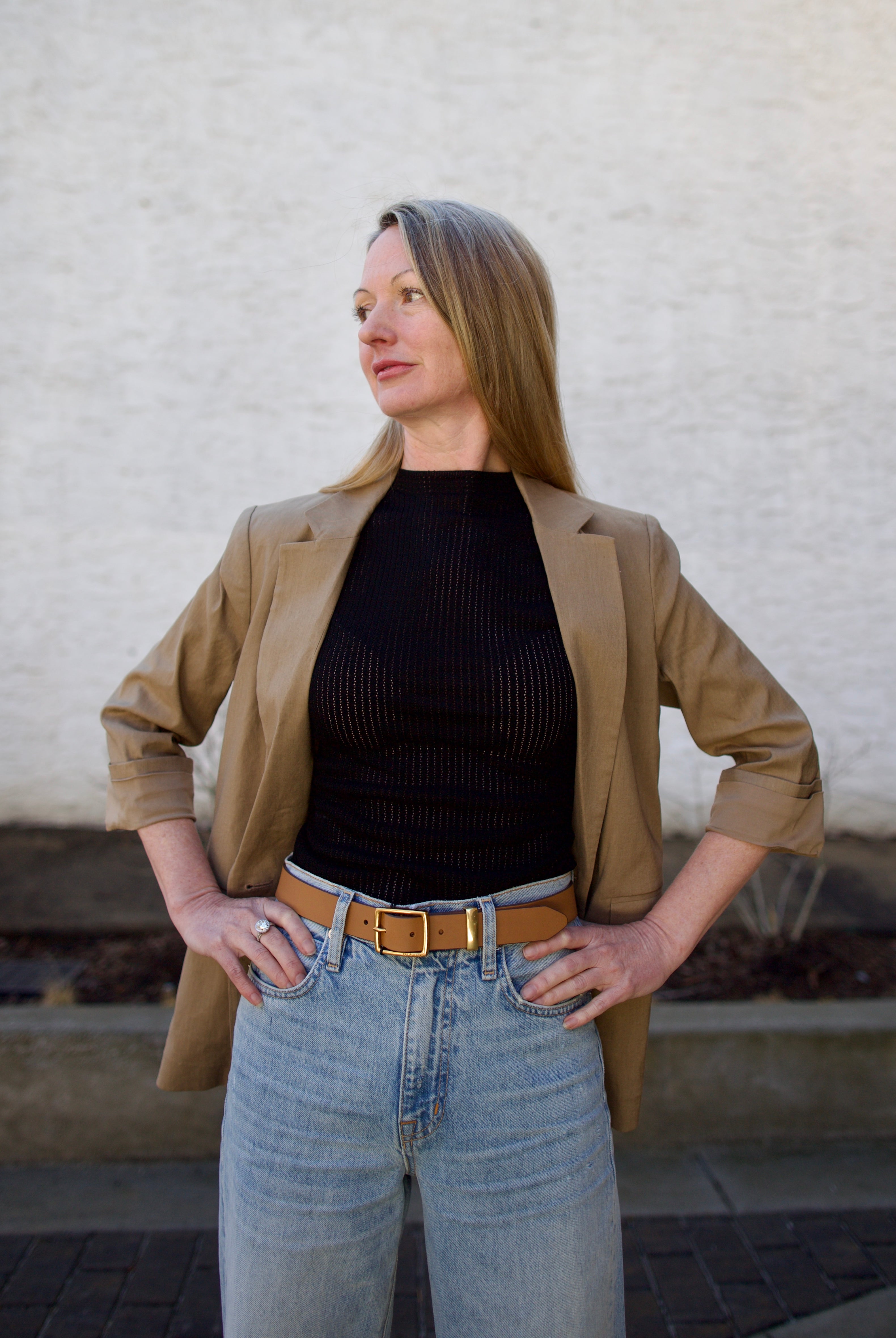 Woman wearing the Rag and Bone Molly Mock Neck black Top in semi-sheer knit construction and expertly designed minimalist silhouette