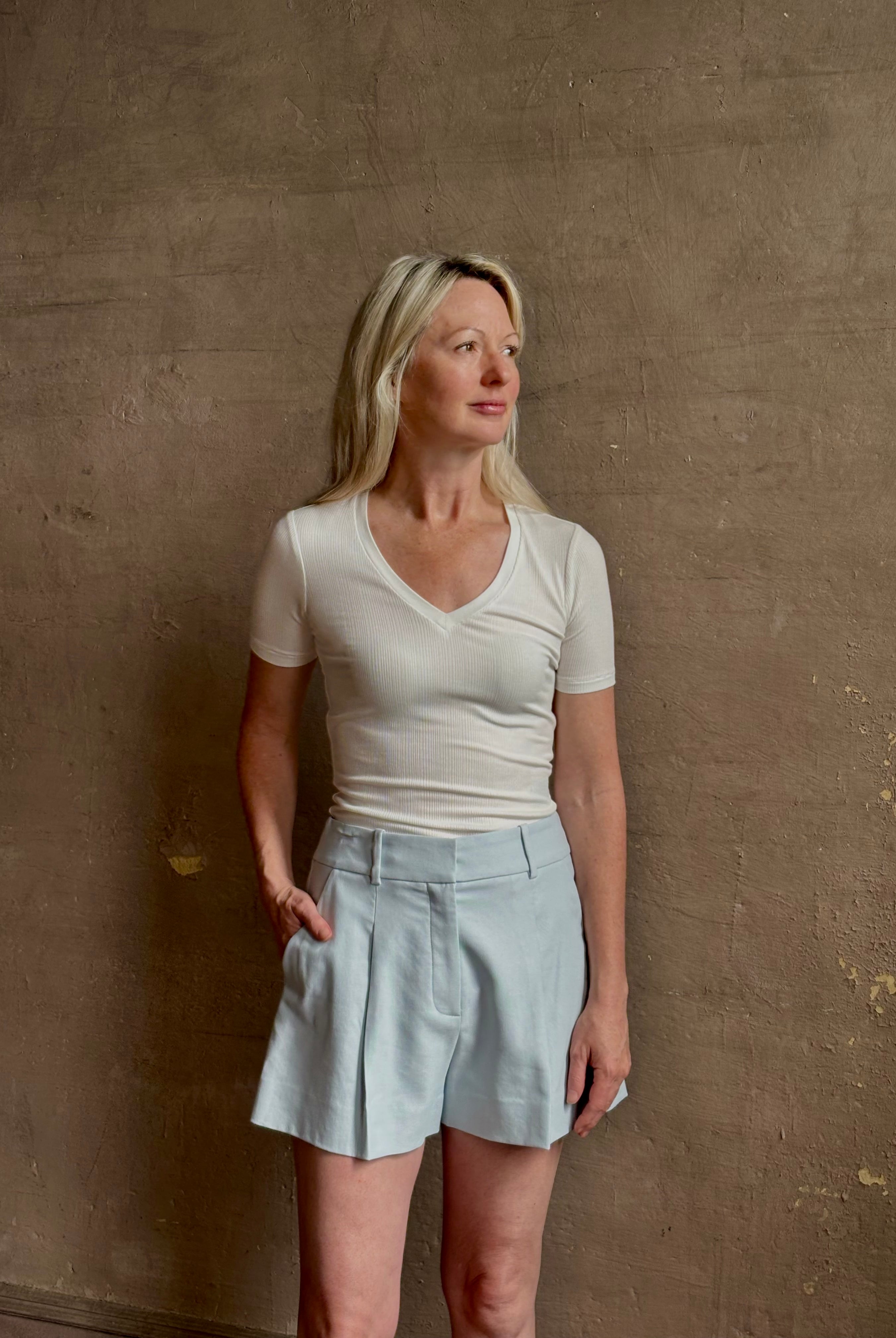 Mature woman wearing the Rag & Bone Luca T-shirt with a rib-knit, V-neck and classic short sleeves in white