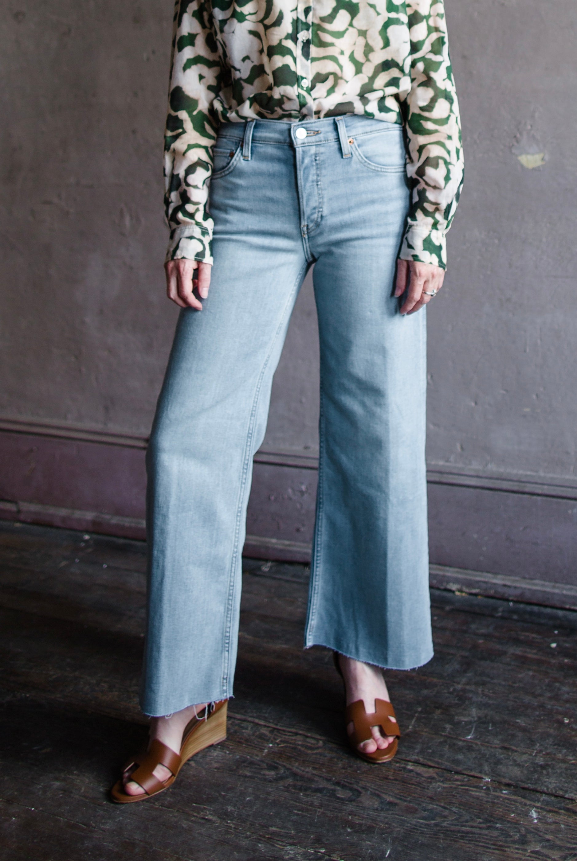 Image featuring a woman wearing the rigid jeans by Re/Done with a mid rise, cropped, wide leg in the Marea wash.