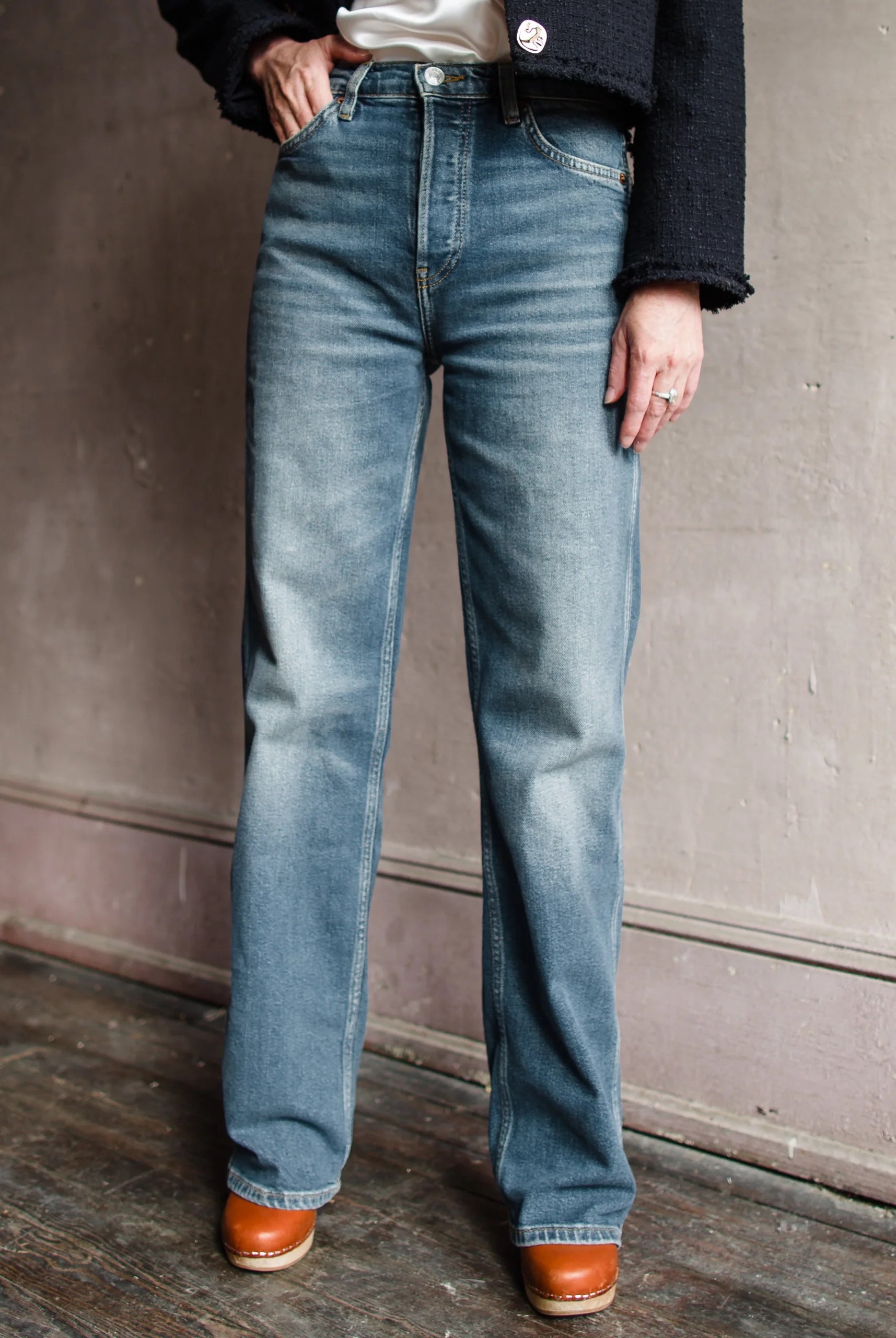 Image featuring a woman wearing the 90s High Rise Loose from Re/Done loose denim in a high rise, straight leg full length and a clean hem in comfort stretch denim.